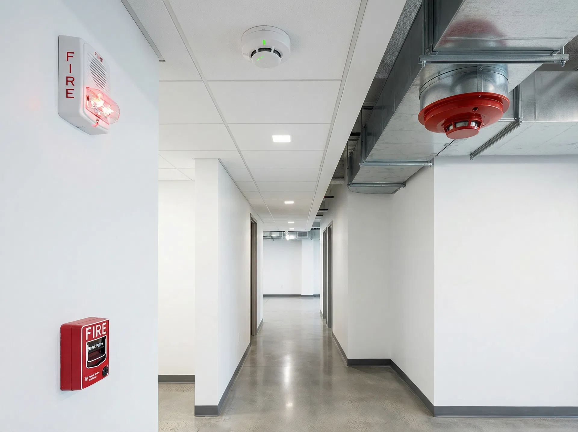 Fire alarm initiating devices including smoke detectors, pull stations, and horn/strobes