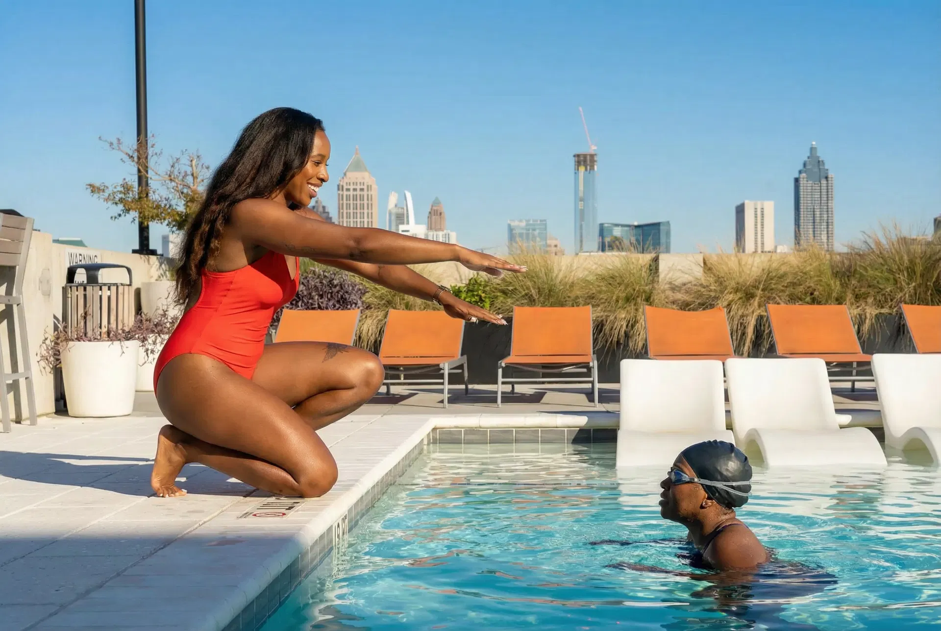 Pasha coaching a student at the pool edge