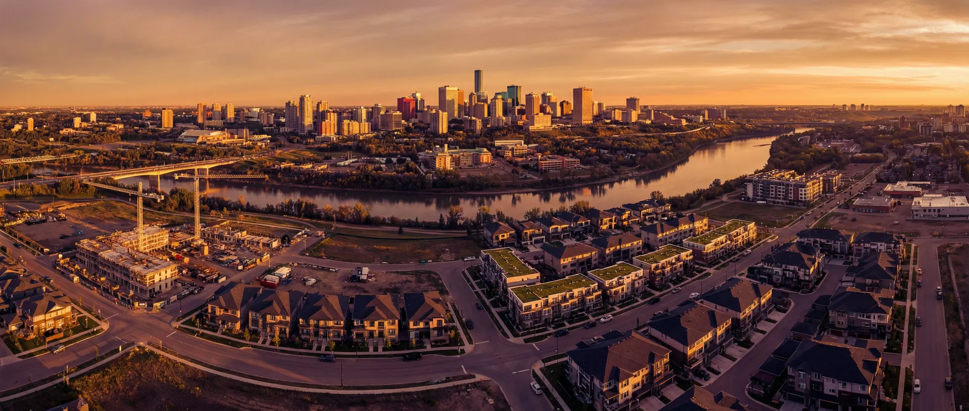 Edmonton skyline at sunset with river valley and new construction