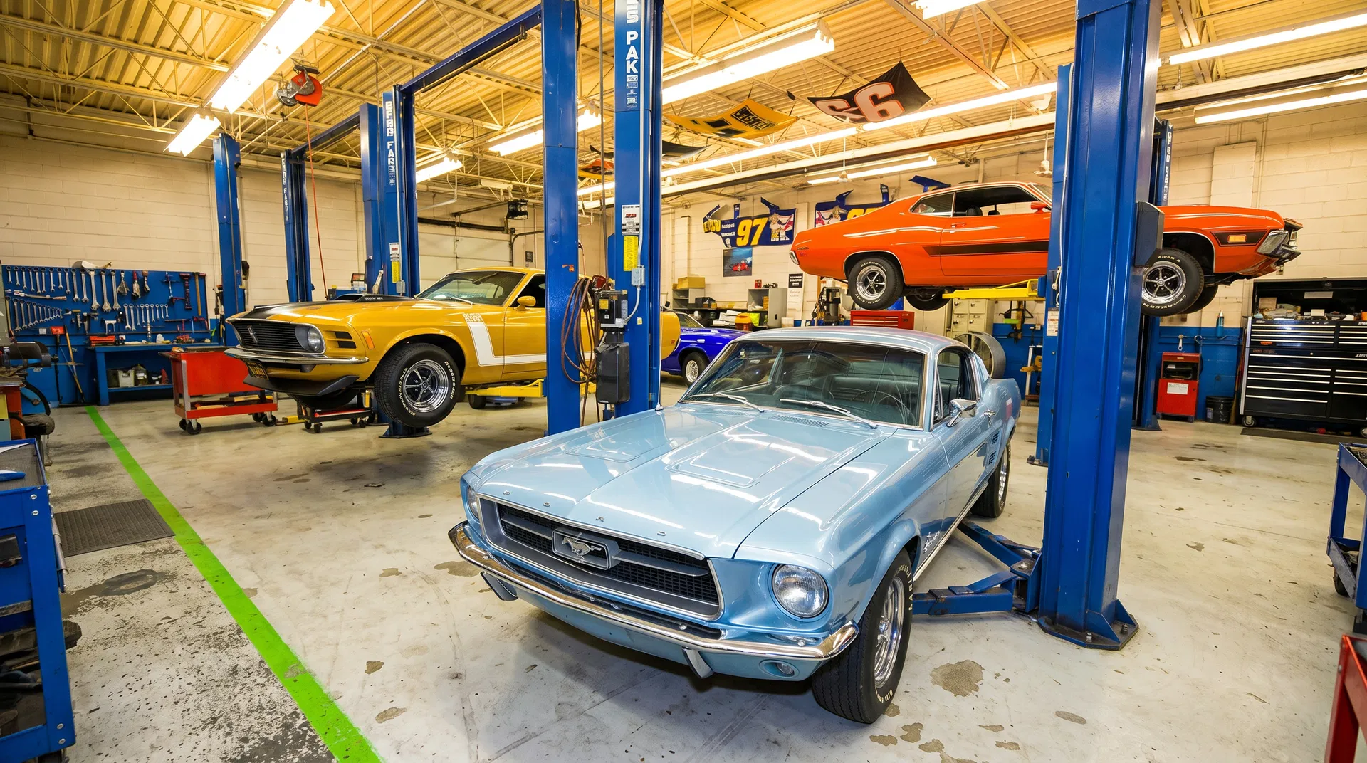 Inside Oval Auto — classic muscle cars on blue lifts