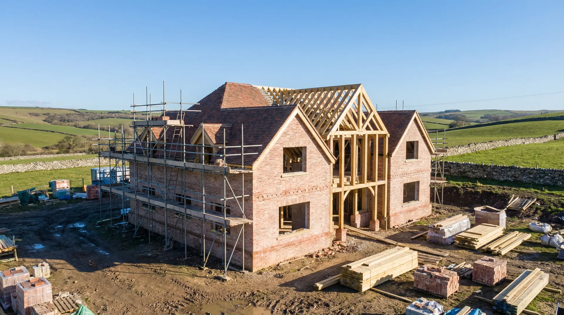 New build detached house under construction in Dorset countryside with brick walls and timber frame by Ross-Read Building Services