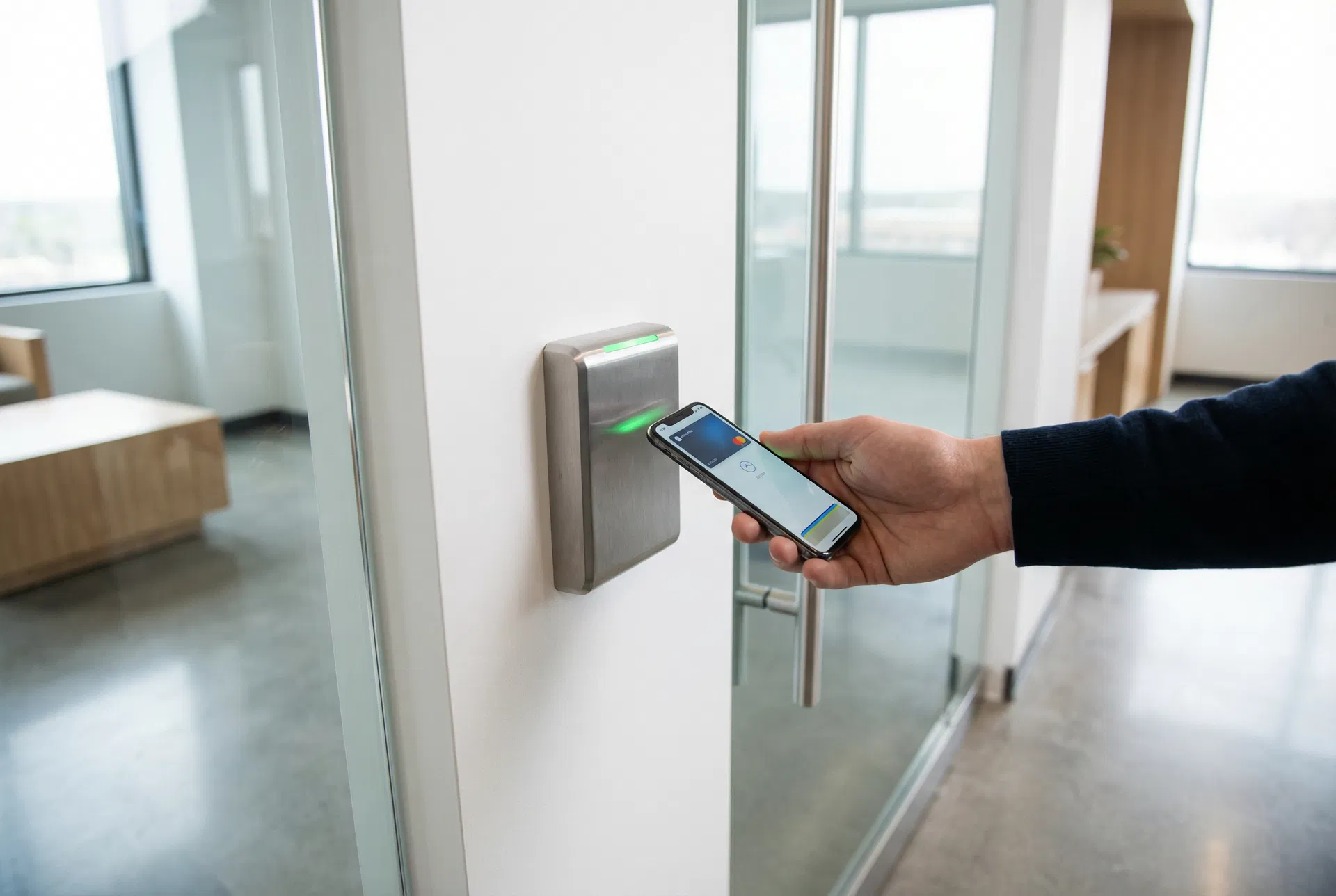 Person using smartphone to access a door via smart access control reader