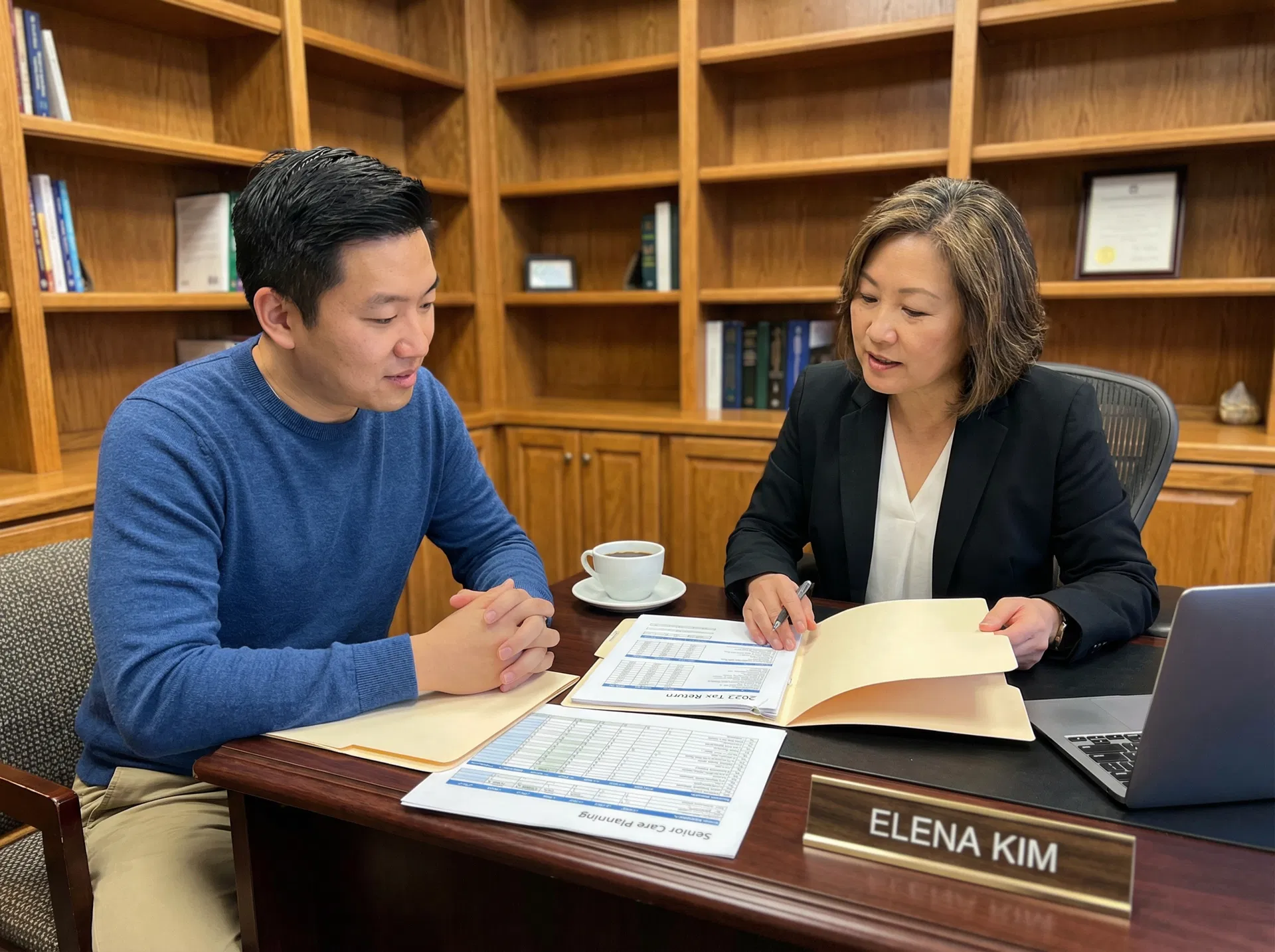 Asian son reviewing tax documents with a financial advisor