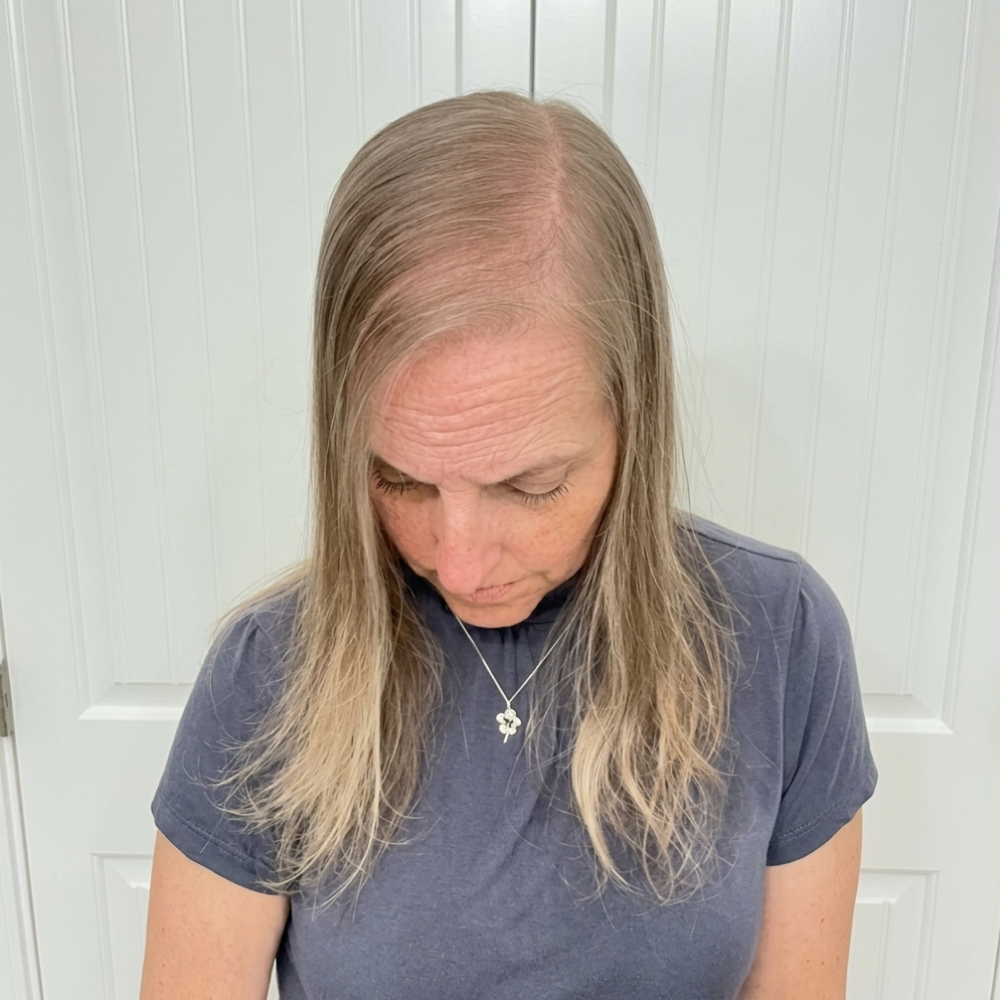 Woman examining hair thickness