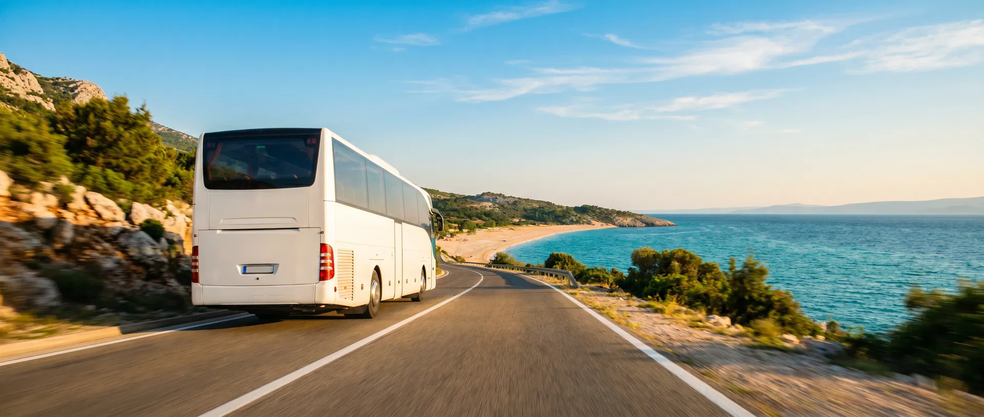 Shuttle bus driving along coastal road to Jaz Beach