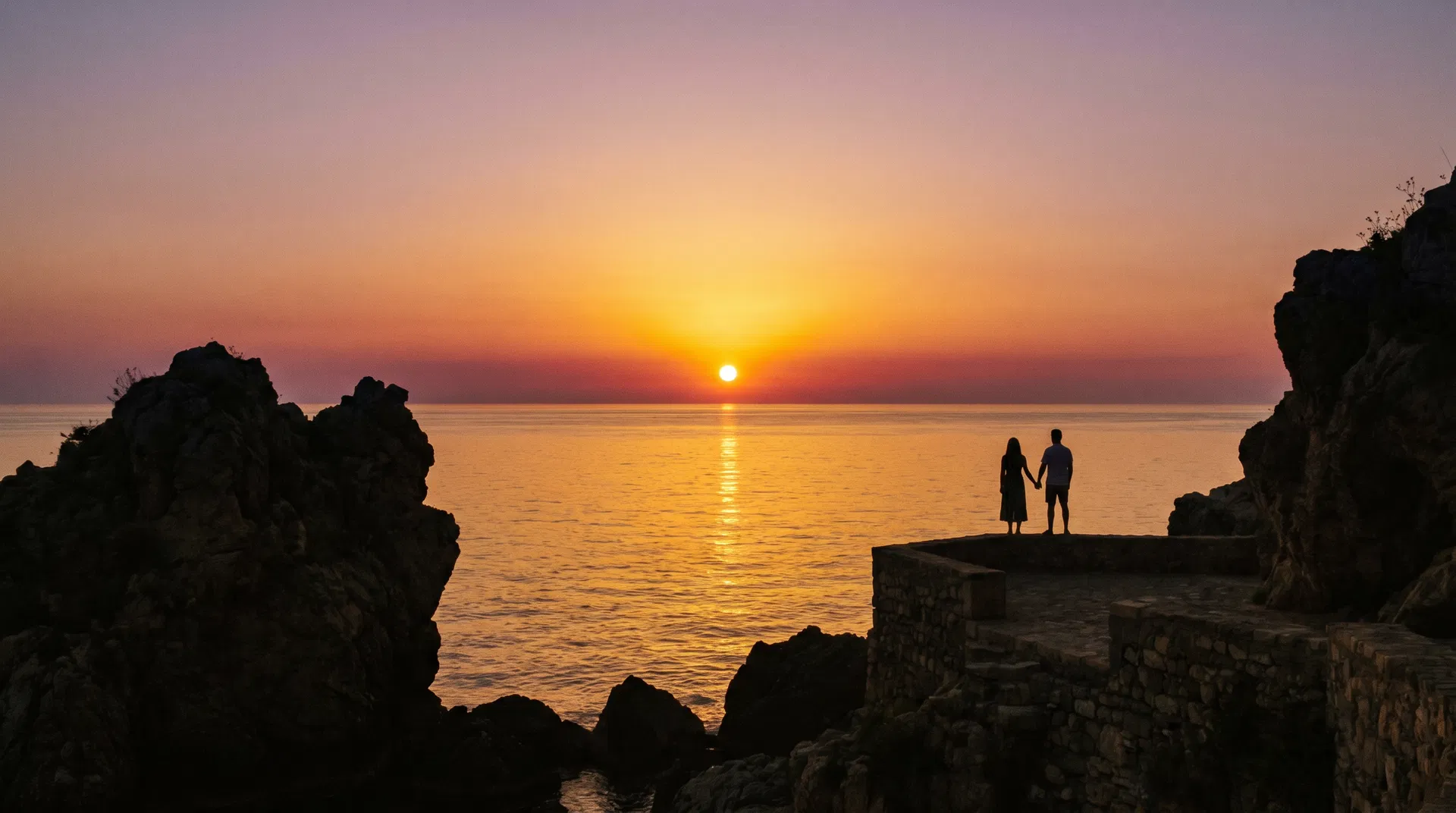 Mediterranean sunset with couple silhouette