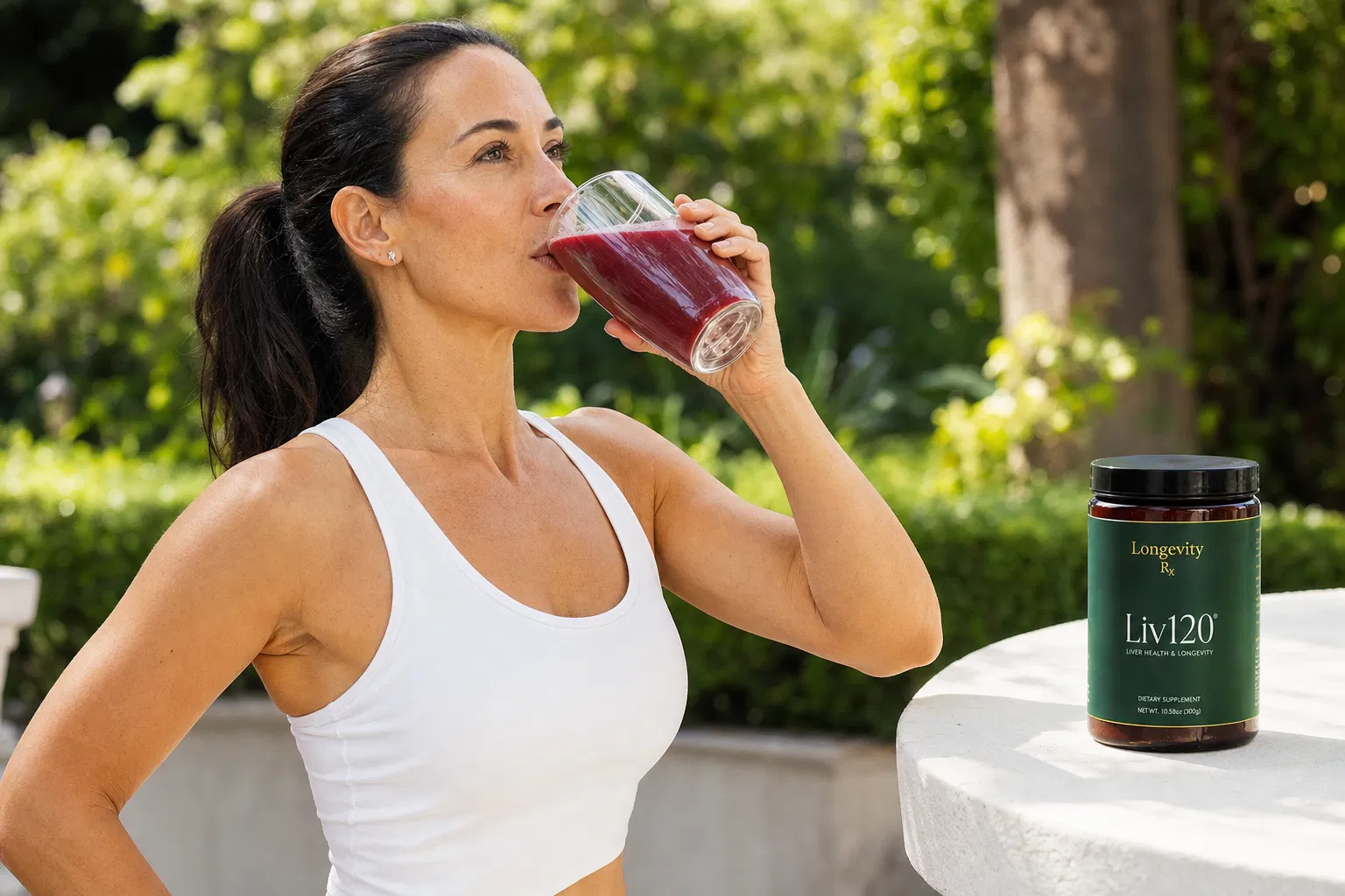 Woman drinking Liv120 supplement outdoors