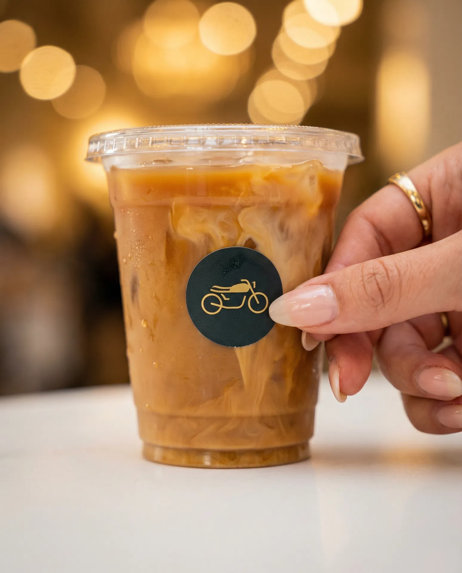 Branded motorcycle logo sticker on iced coffee cup