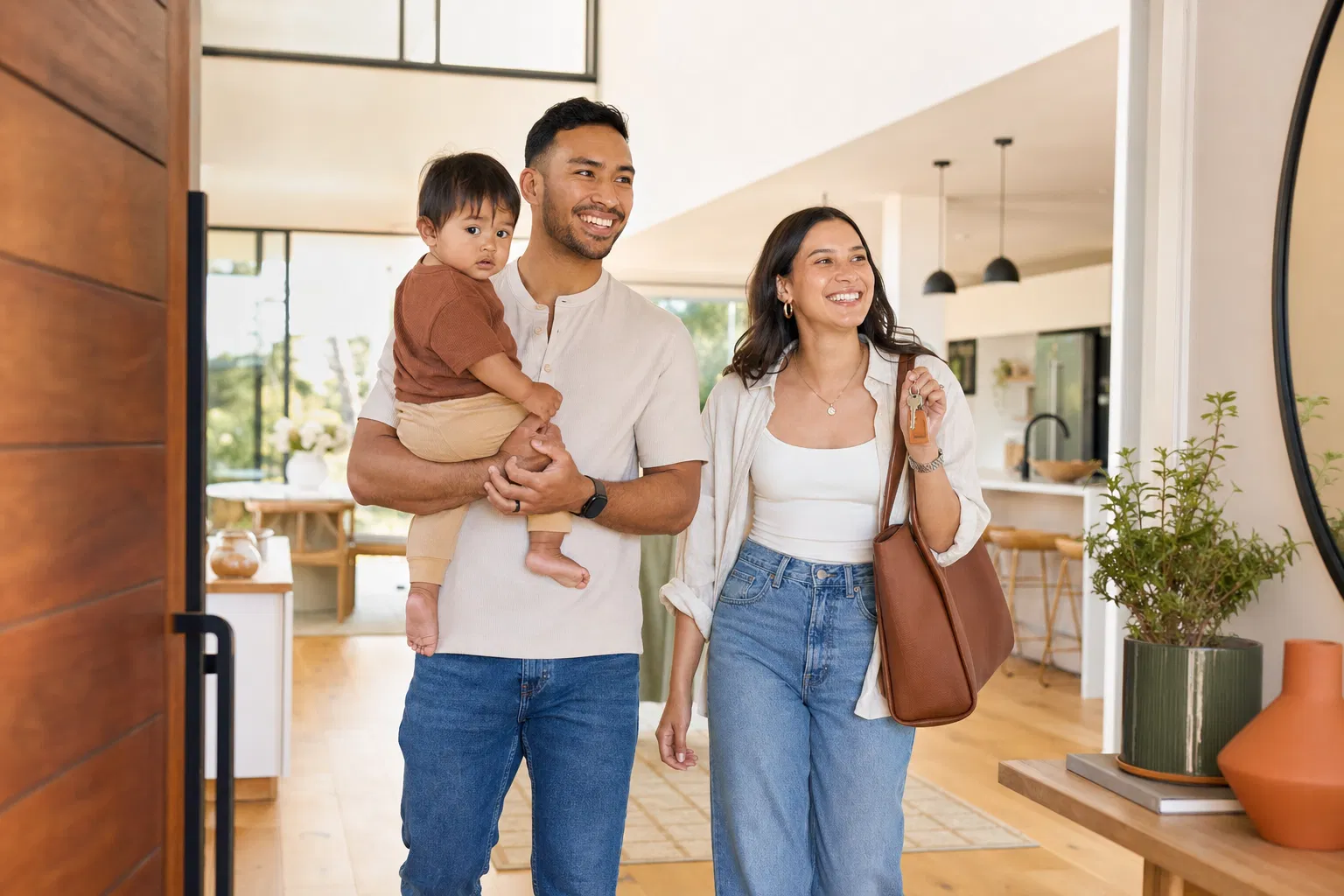 Happy family walking into their new home in Fresno