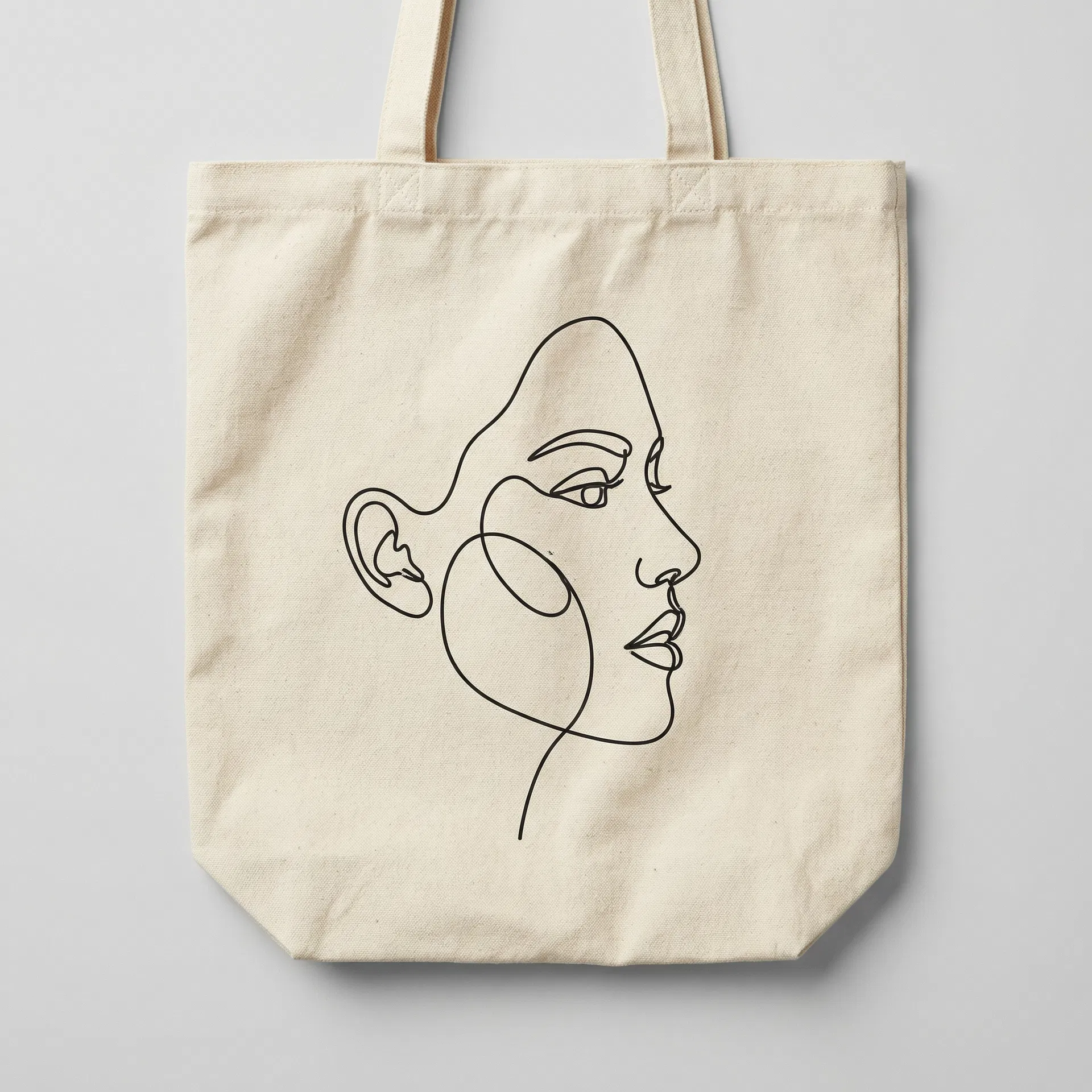 Natural canvas tote bag with minimalist line art face design