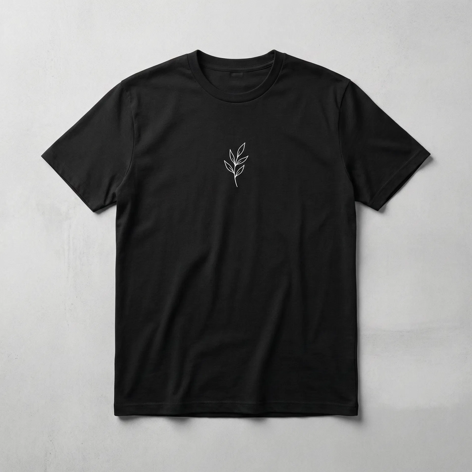 Black premium t-shirt with minimalist white botanical leaf design