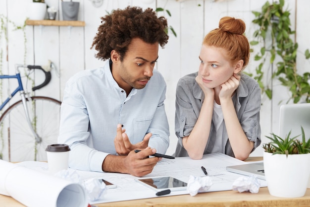 Confident enthusiastic Afro American senior engineer explaining passionately his point of view