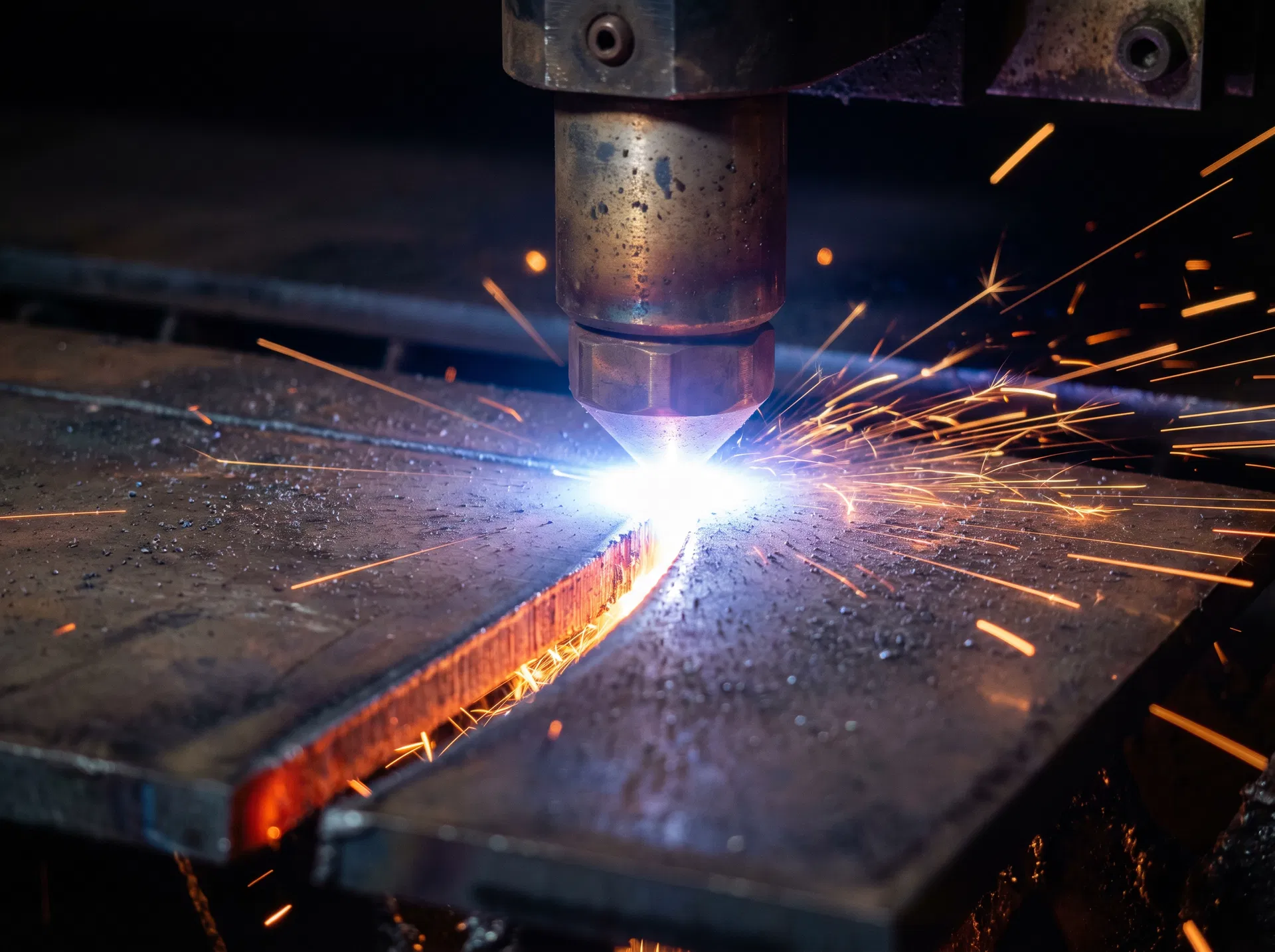 CNC plasma torch cutting steel plate close-up