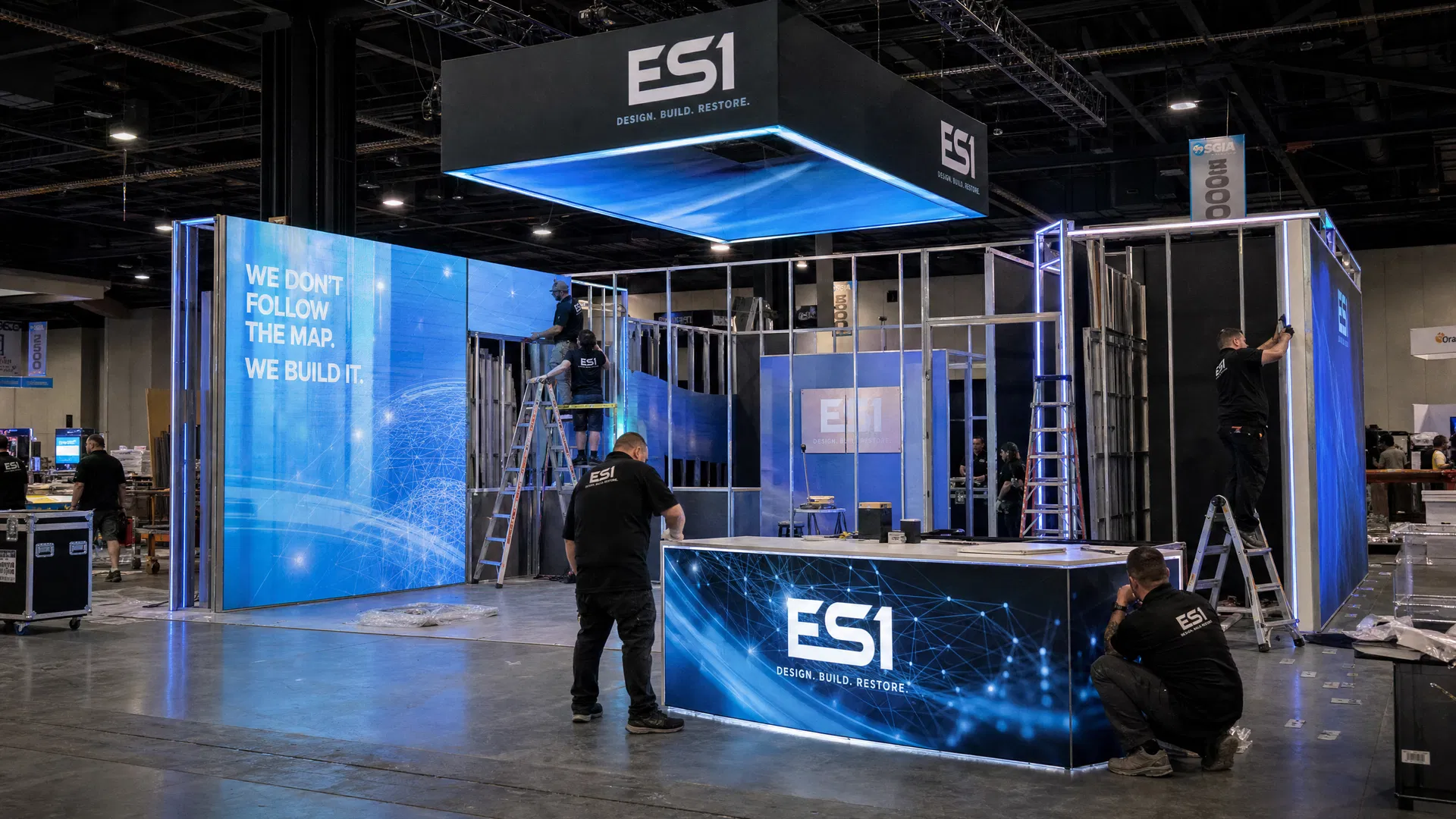 Technicians assembling LED exhibit components at a trade show