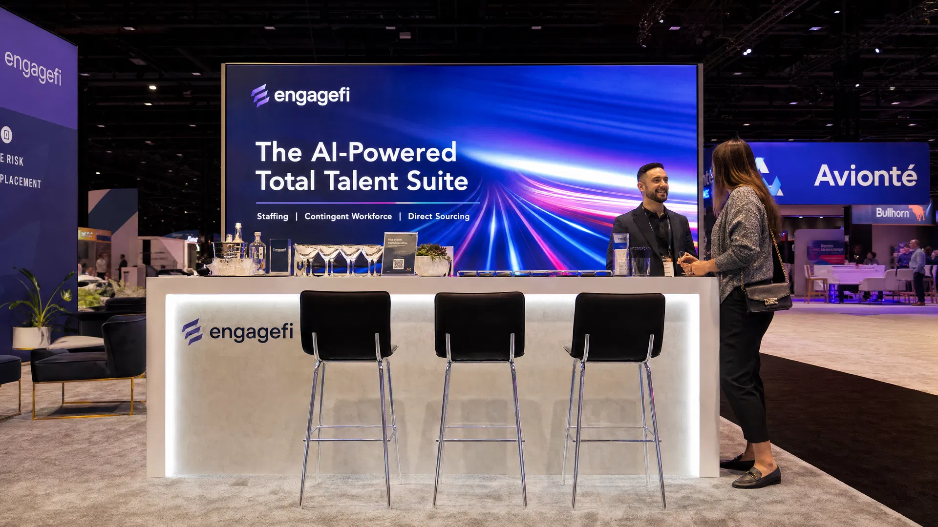 Stylish bar-height counter area with stools and LED-lit front panel at a trade show exhibit