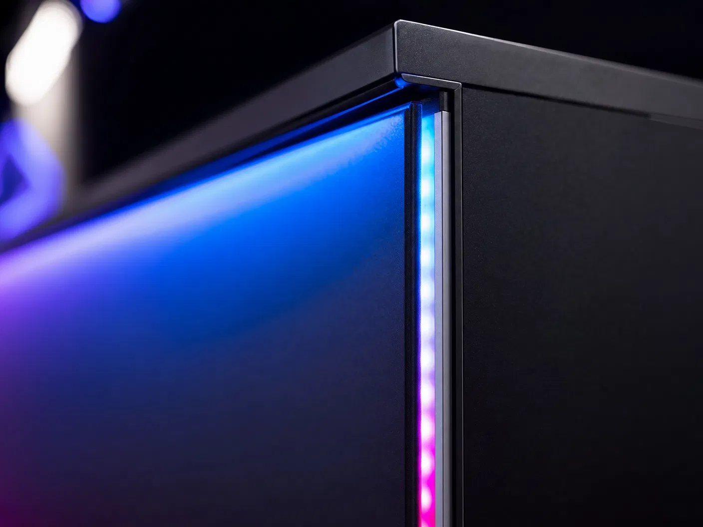 Close-up of LED edge lighting strip with gradient color transition from blue to magenta