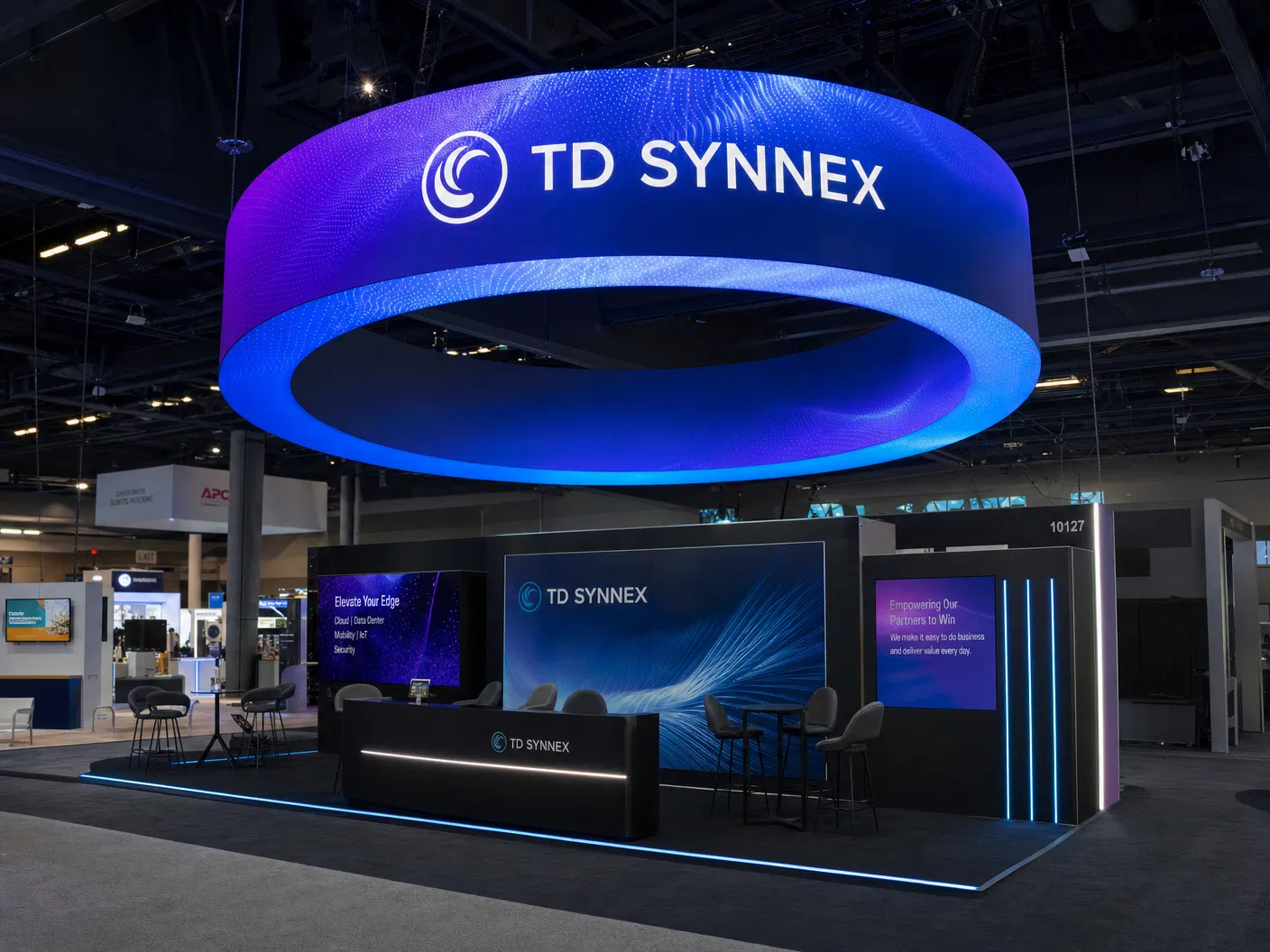 Stunning circular LED hanging sign above a premium trade show exhibit booth, displaying vibrant brand content in 360 degrees