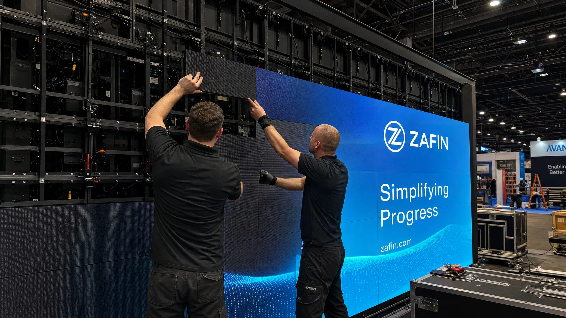 Professional technicians installing LED video wall panels at a trade show convention center