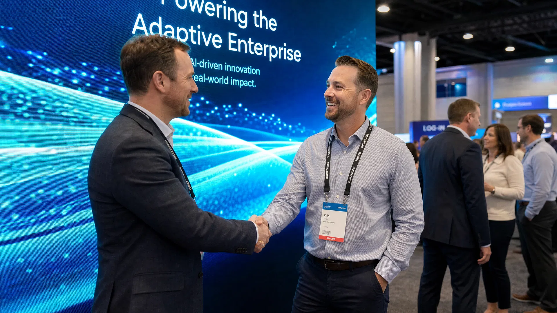 Business professionals networking in front of LED video wall at trade show