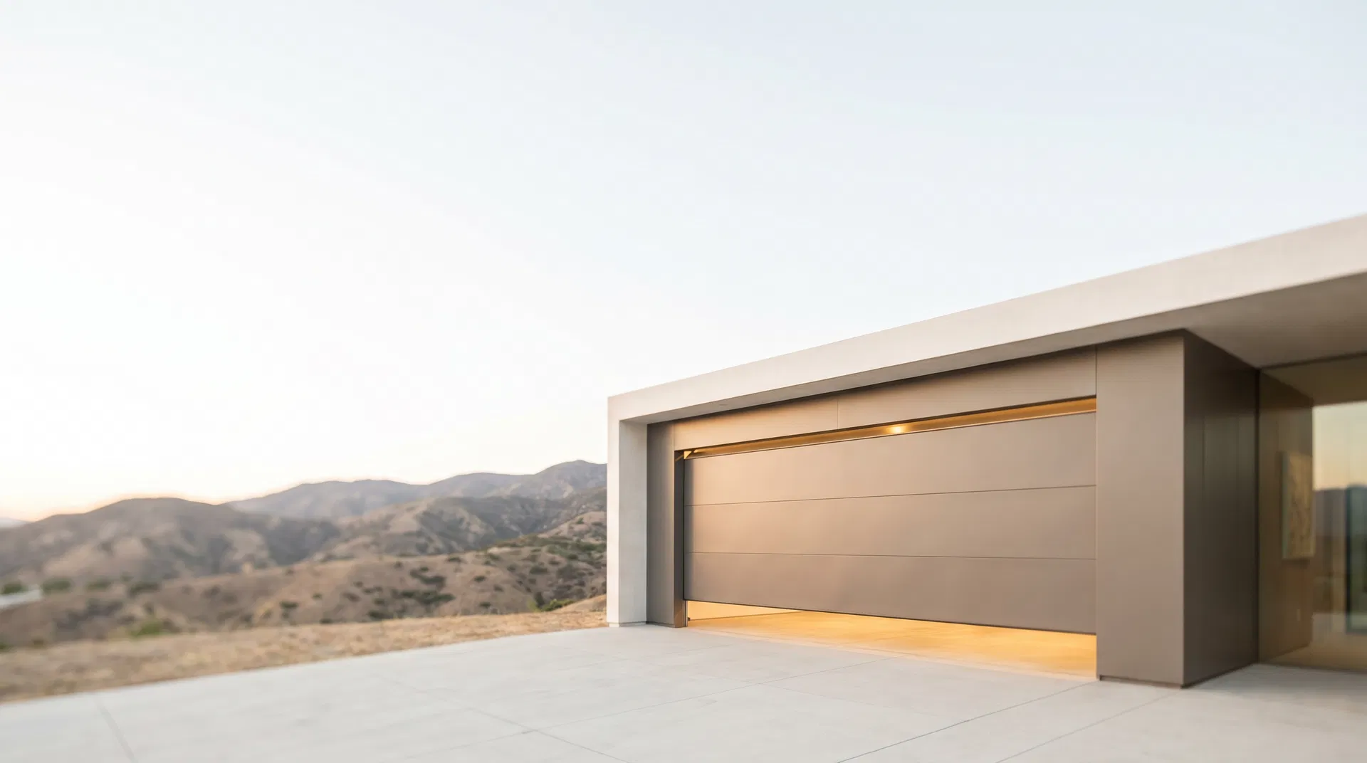 Modern Azusa hillside home with a contemporary garage door glowing at golden hour
