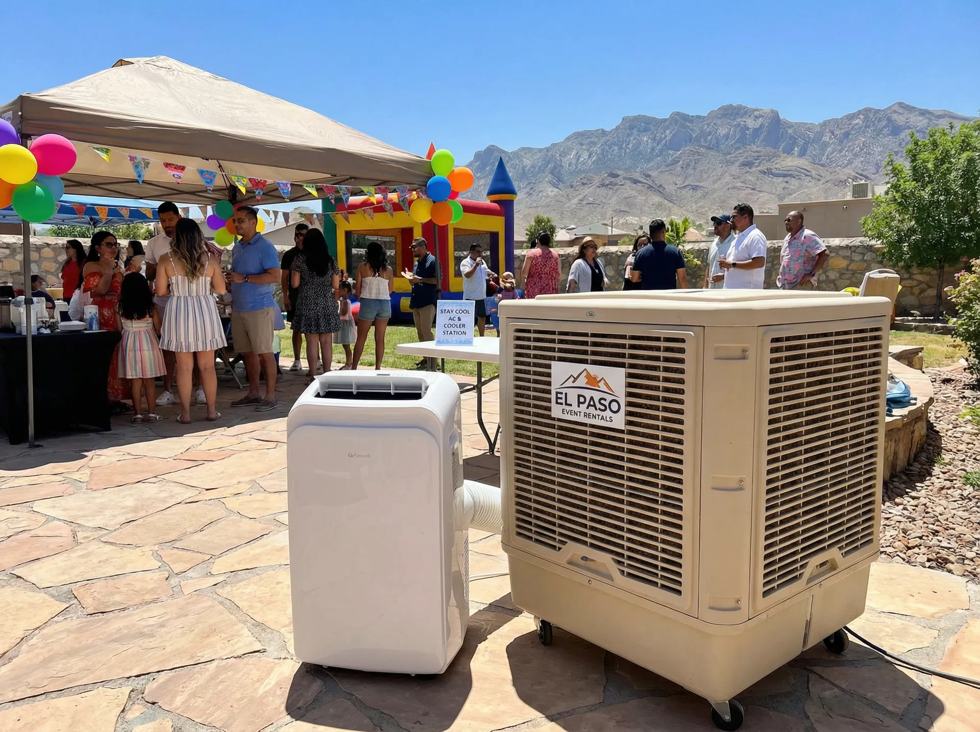 Portable air conditioner and evaporative cooler set up at a backyard birthday party in El Paso, TX with Franklin Mountains visible, bounce house and guests in background — Sweet & Sassy Creations portable AC rental