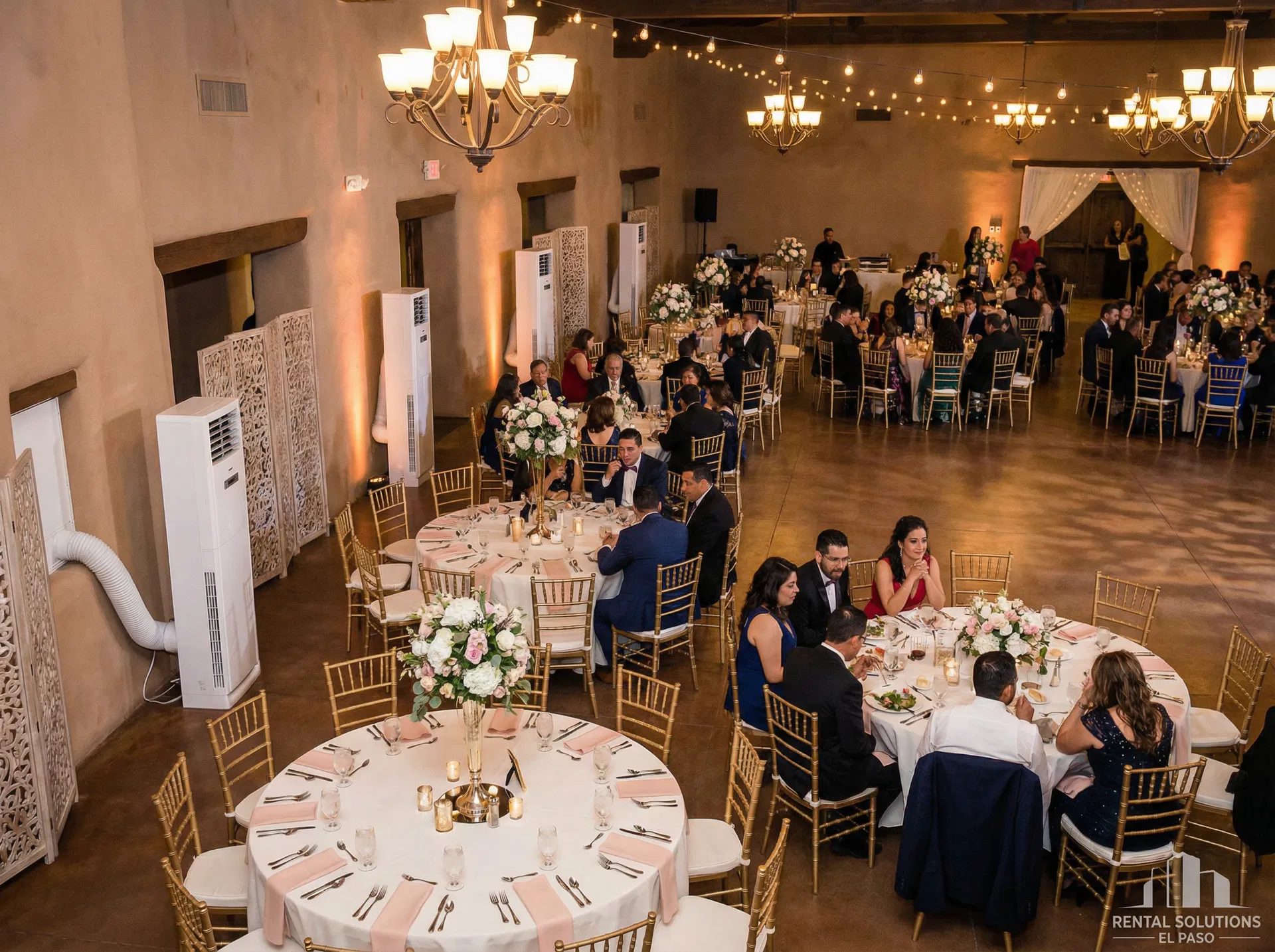 Sleek white tower portable air conditioning units discreetly placed along the walls of an elegant event hall during a quinceañera or wedding reception in El Paso, TX — Sweet & Sassy Creations indoor AC rental