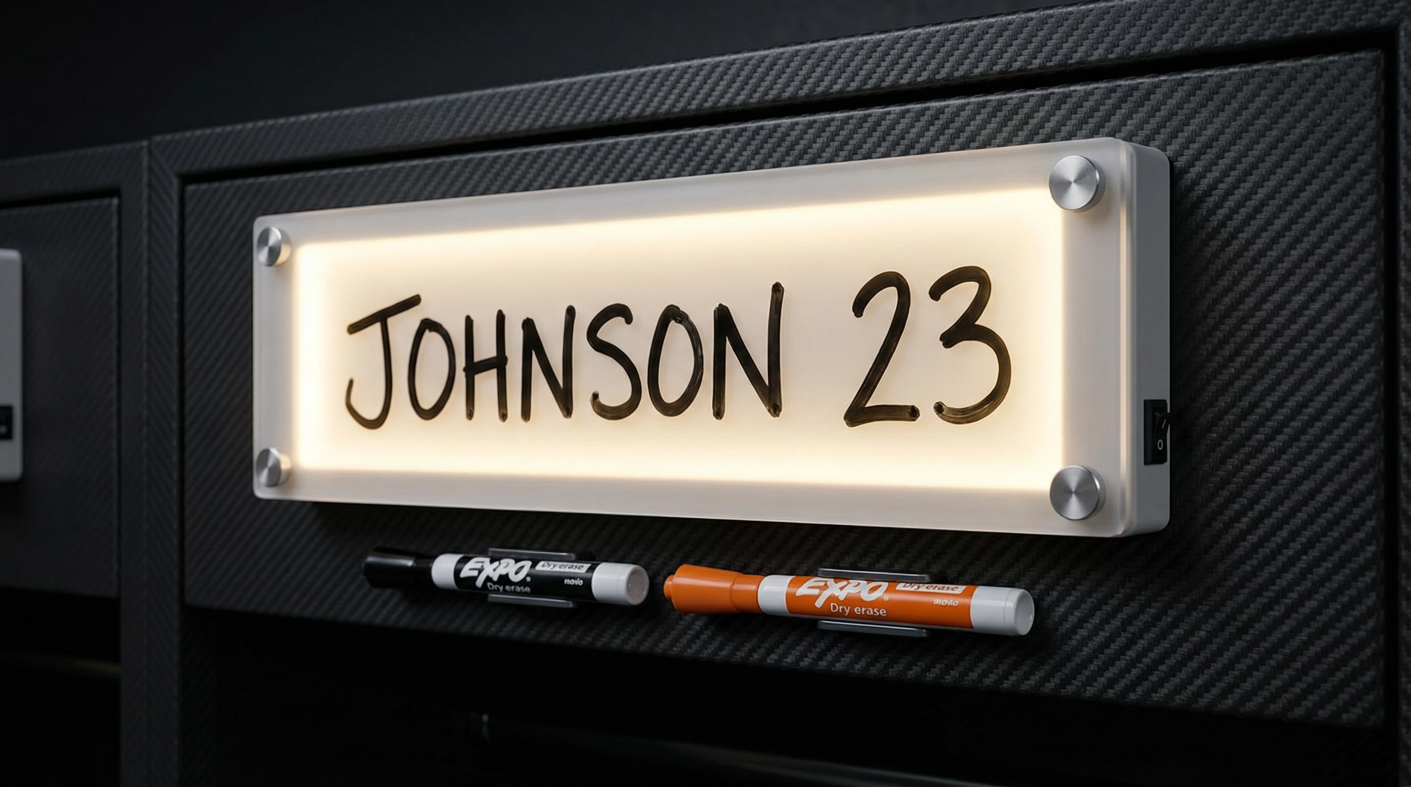 Dry-erase LED nameplate close-up showing JOHNSON 23 glowing