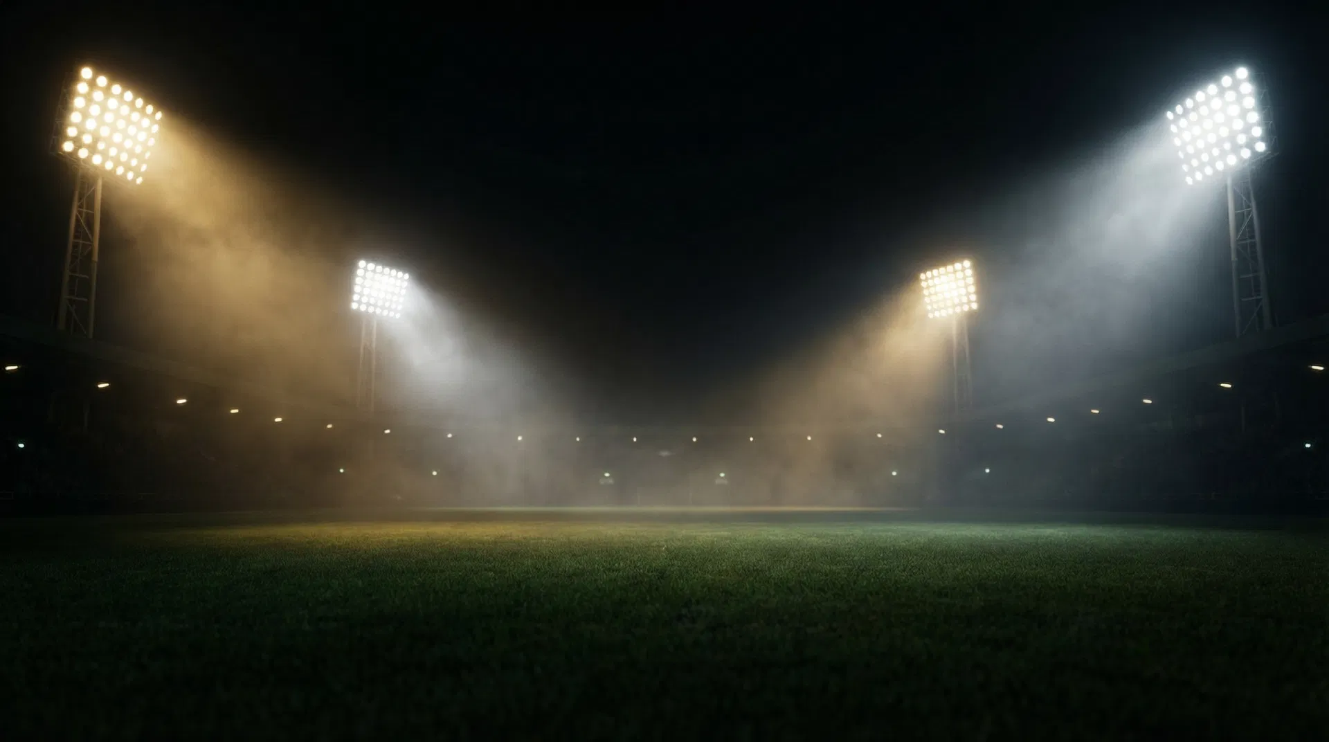 Stadium lights illuminating a sports arena at night