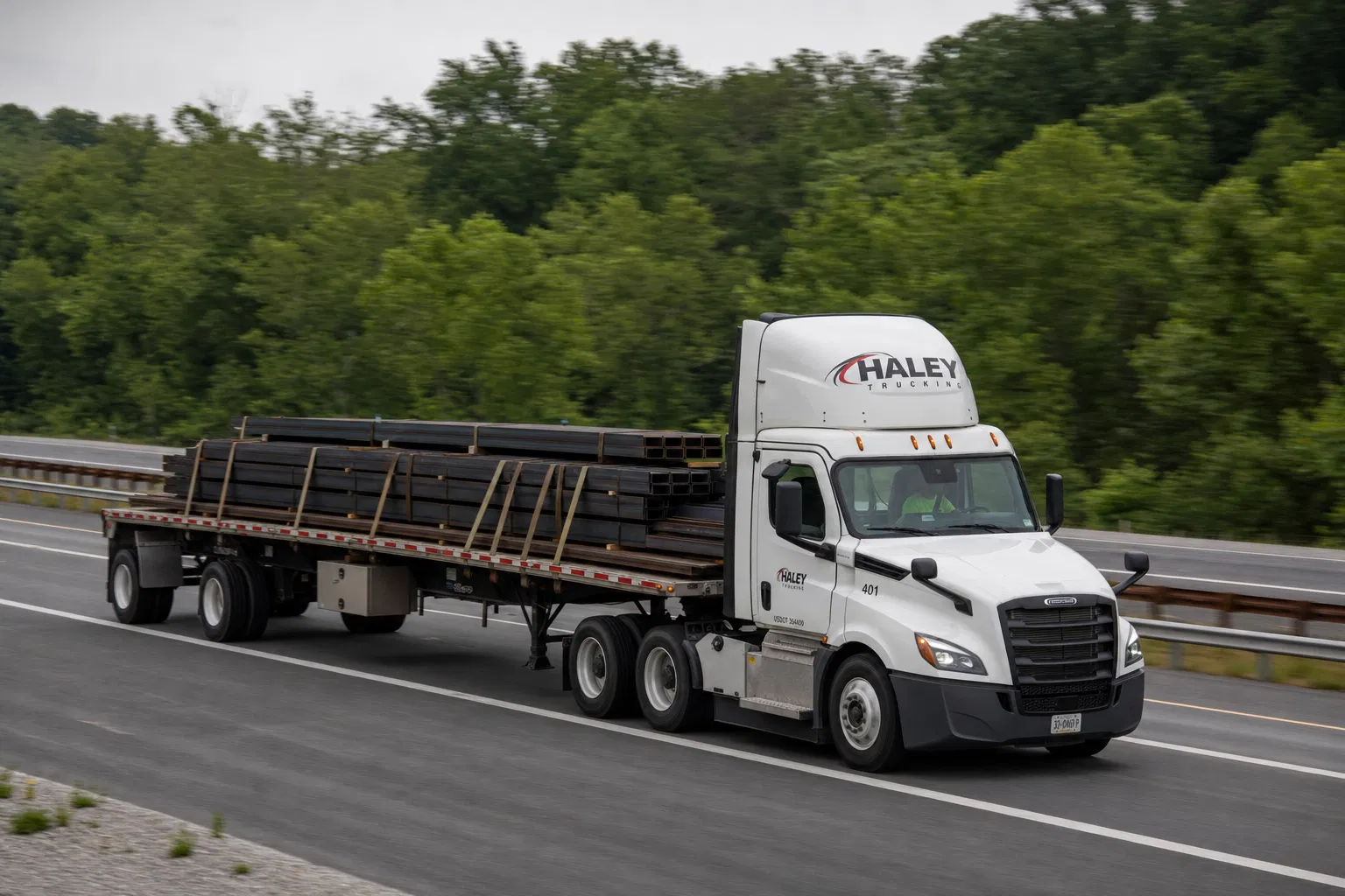 Flatbed truck hauling steel beams on Mid-Atlantic highway