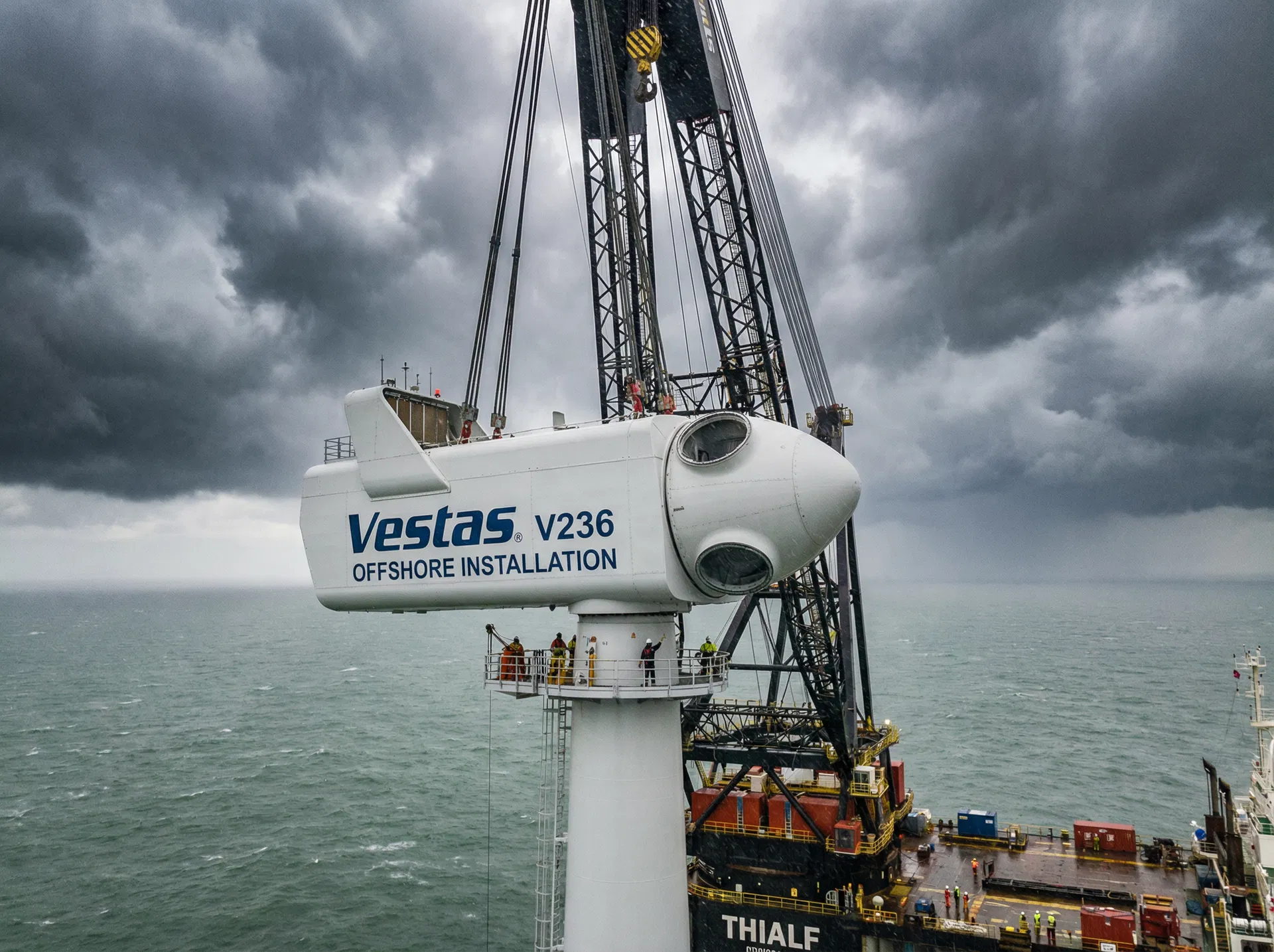 Nacelle being lifted to the top of an offshore wind turbine tower by crane vessel