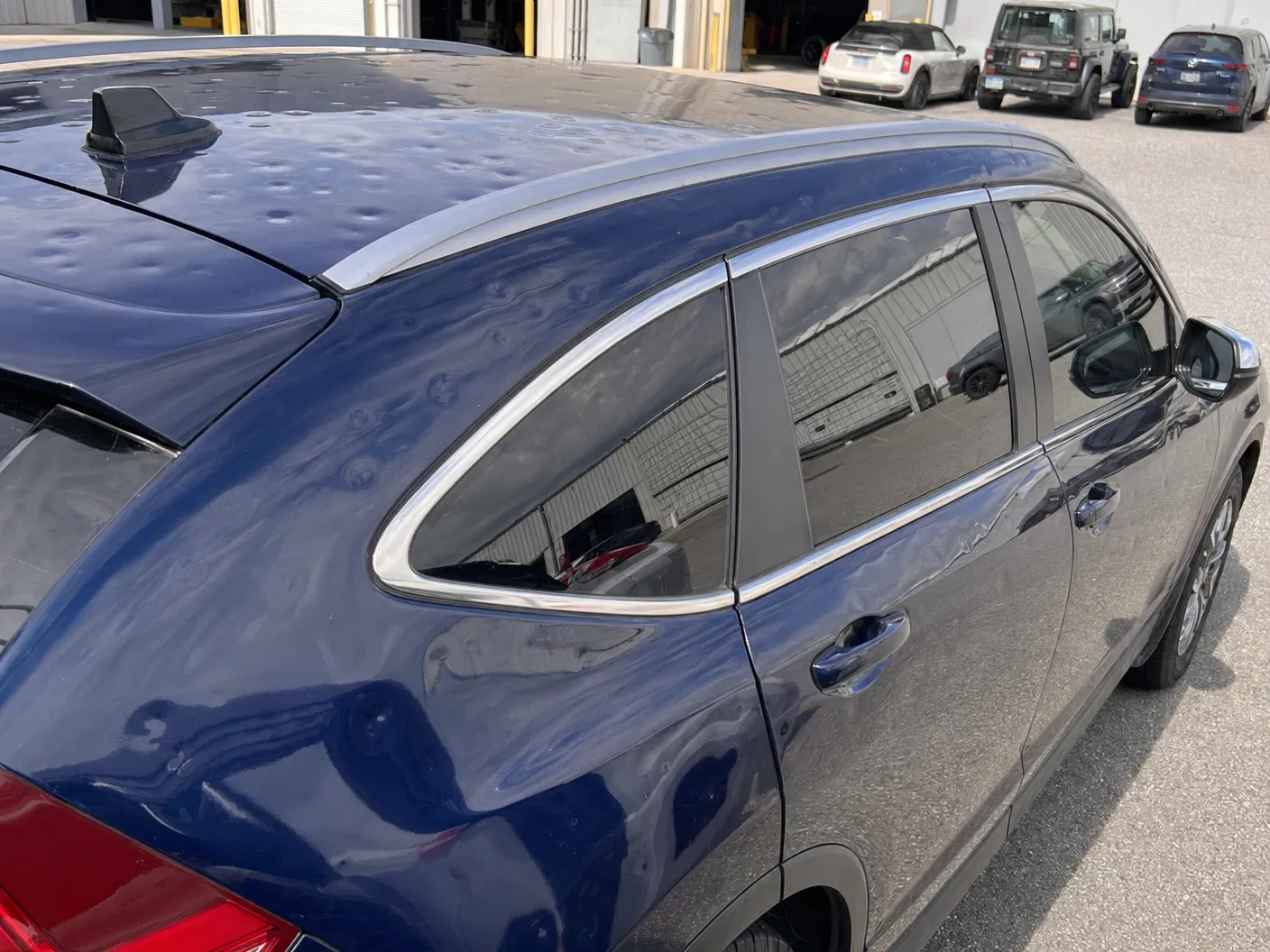Blue SUV — Roof & Side Panel Damage