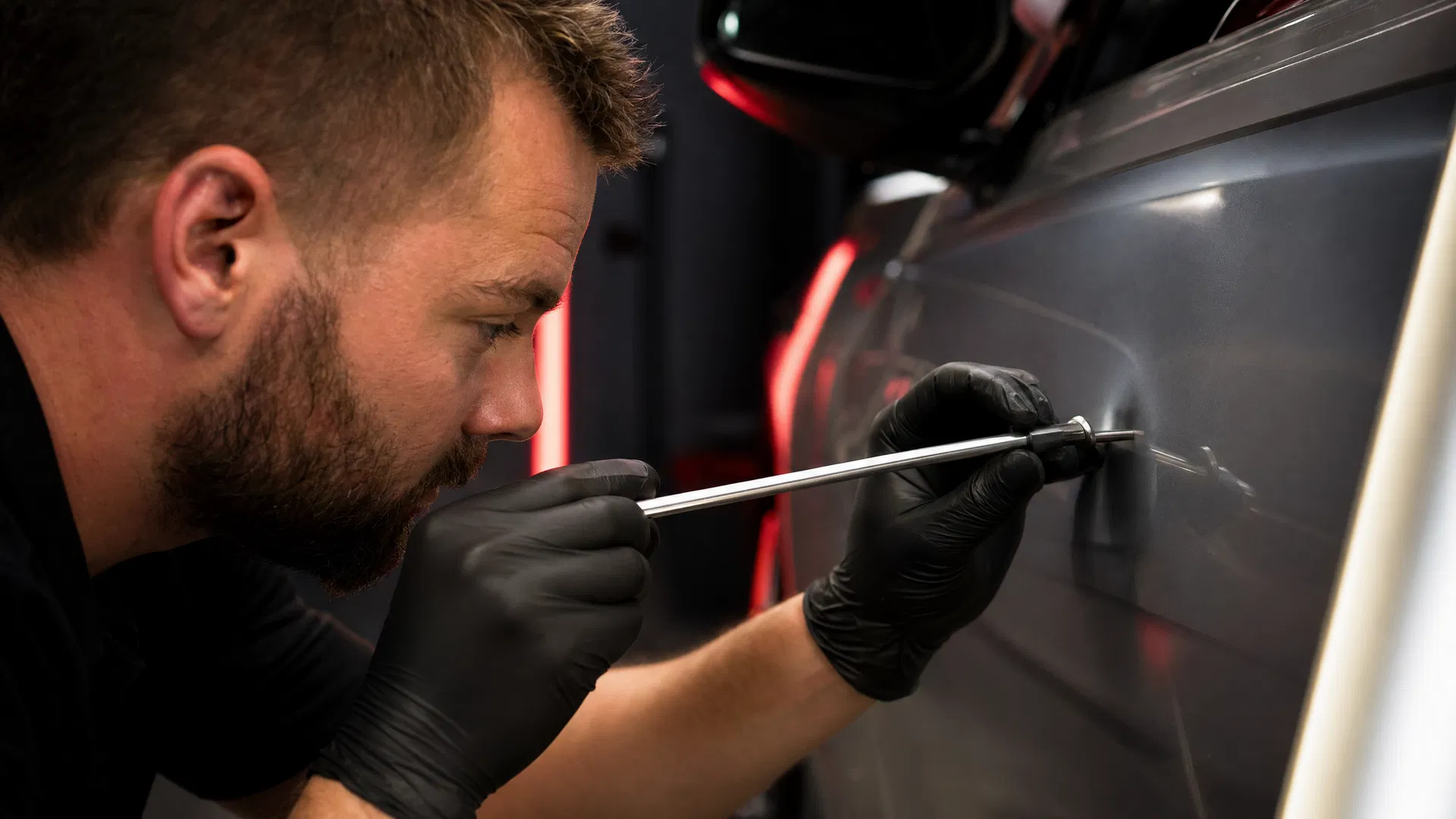 PDR technician performing precision dent repair