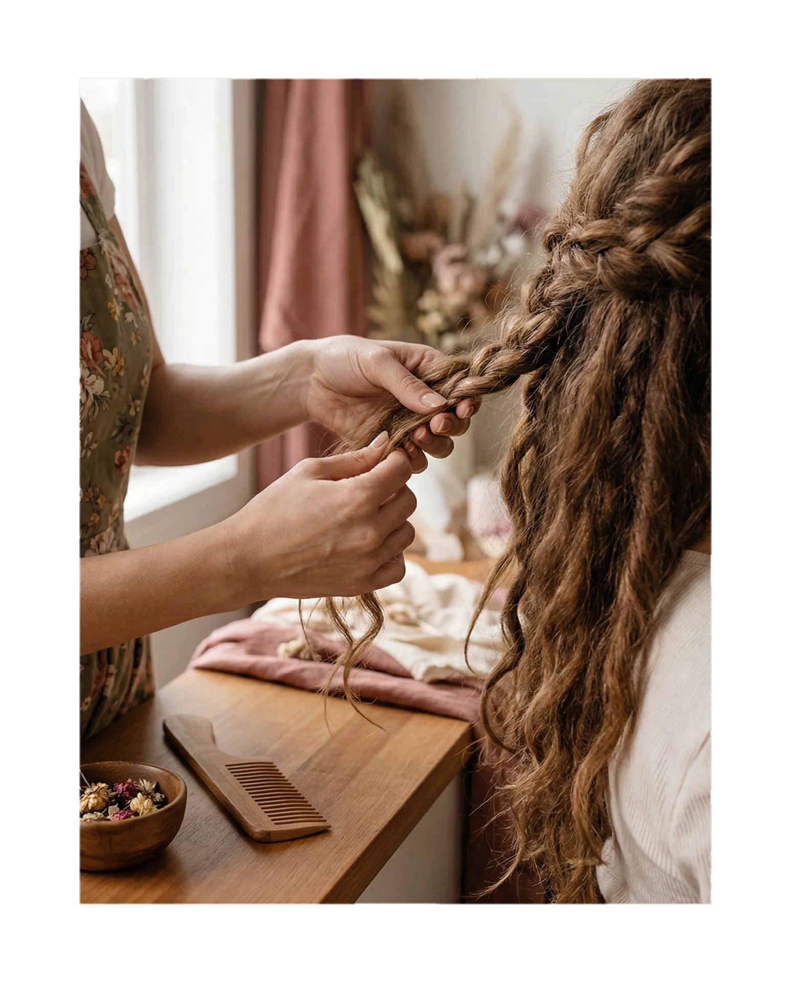 Elegant braided hairstyle being created in a warm salon setting