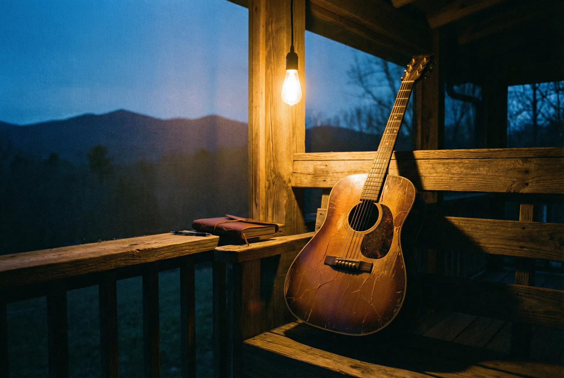 Acoustic guitar on a mountain porch at dusk