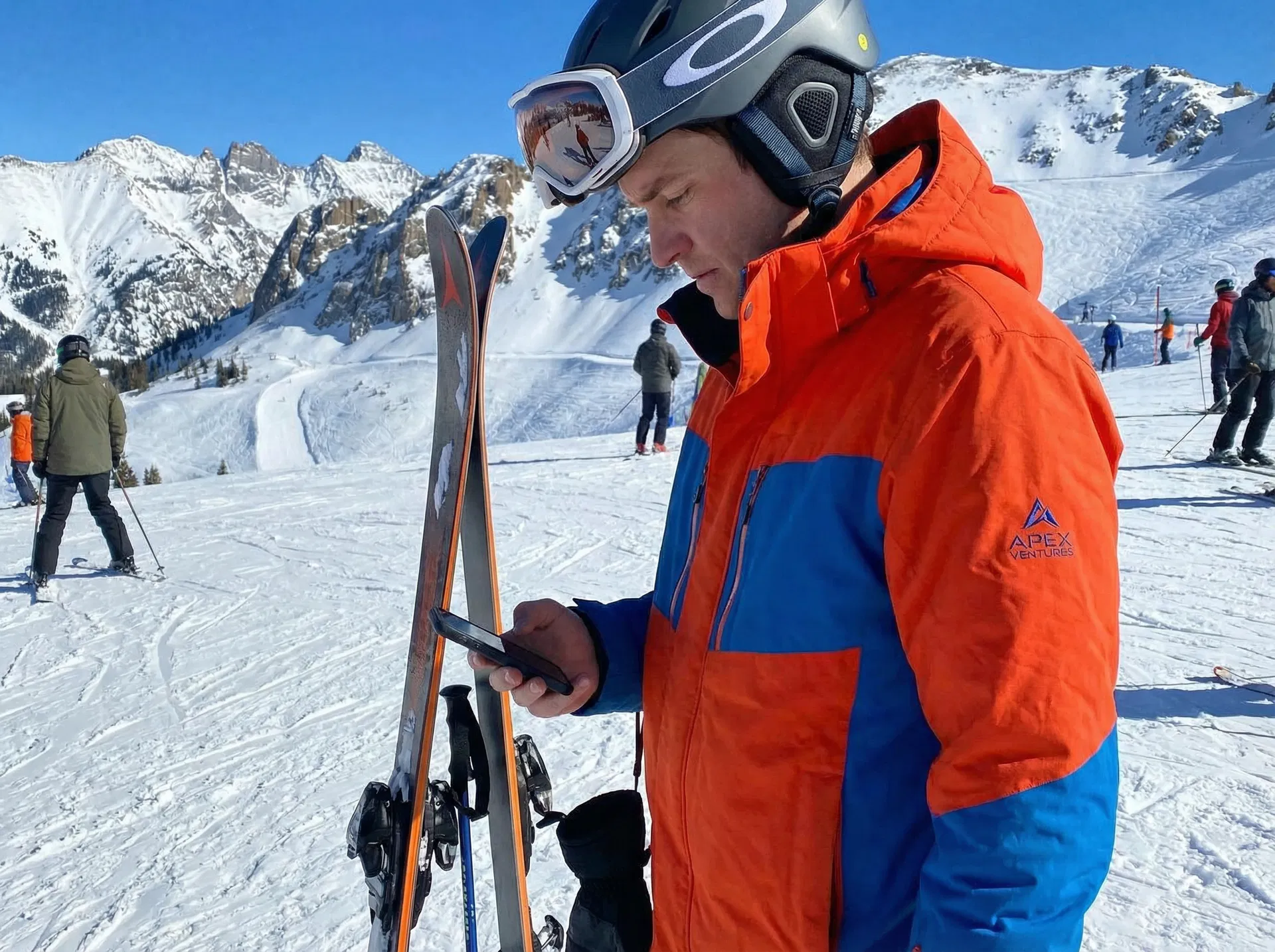 Business owner on ski slope checking phone