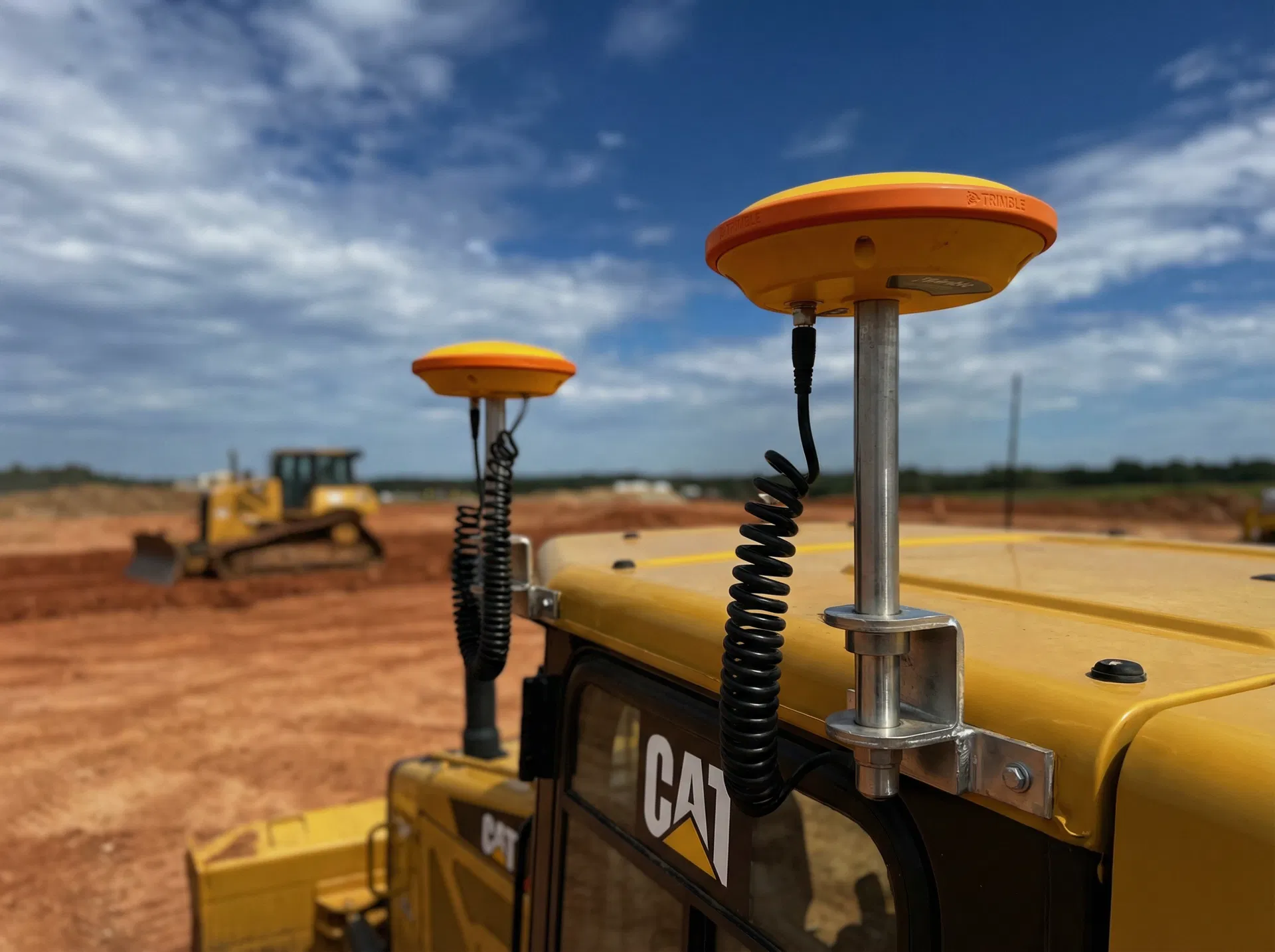 Trimble GNSS antennas mounted on CAT excavator cab at Utah construction site