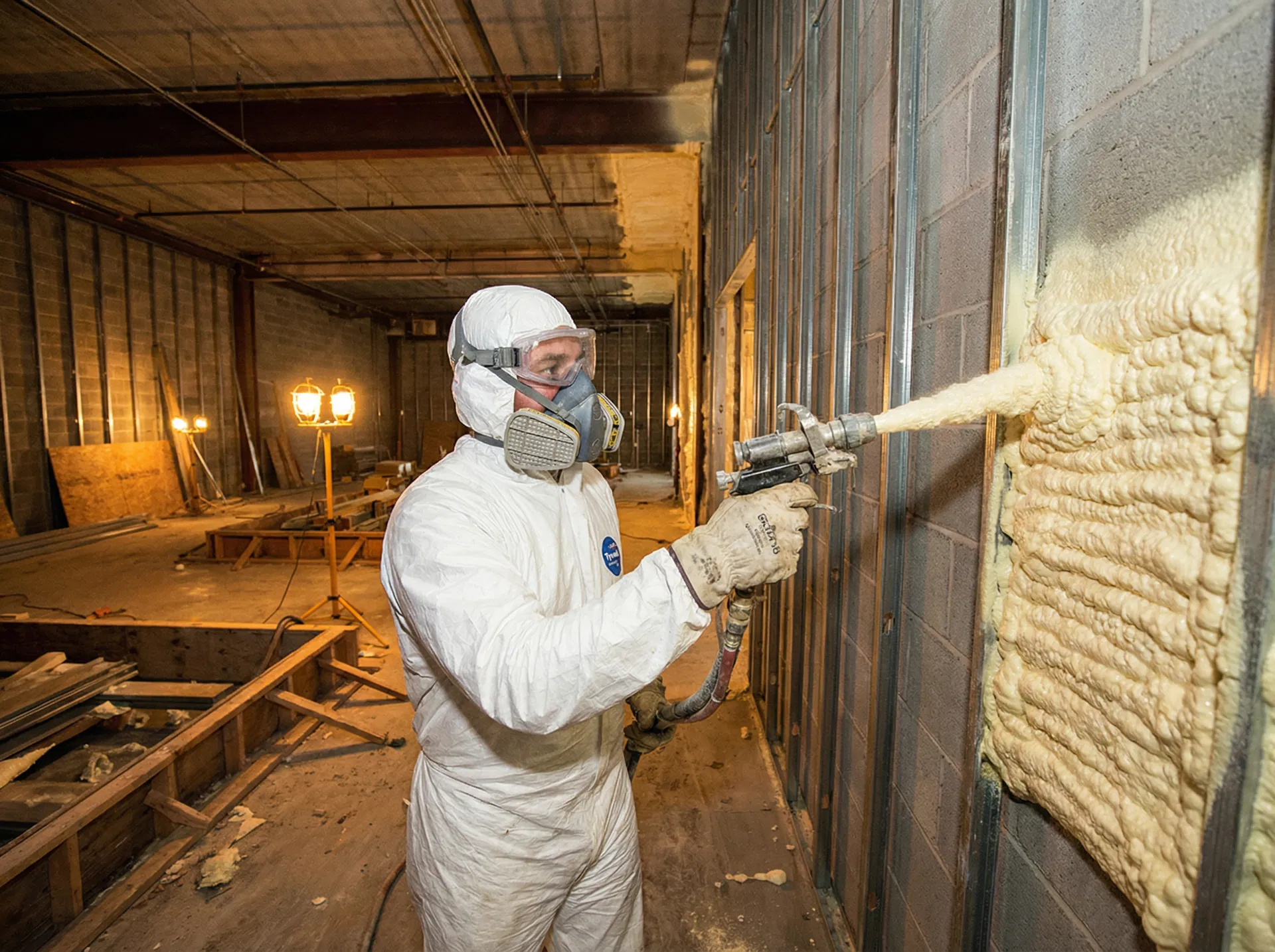 Worker applying an advanced eco-friendly wall coating to a commercial building