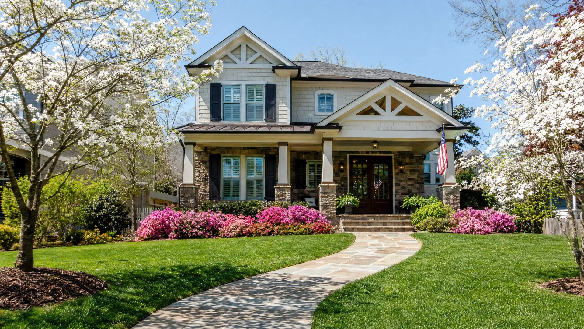 Beautiful Tennessee craftsman home exterior in spring with blooming dogwood trees