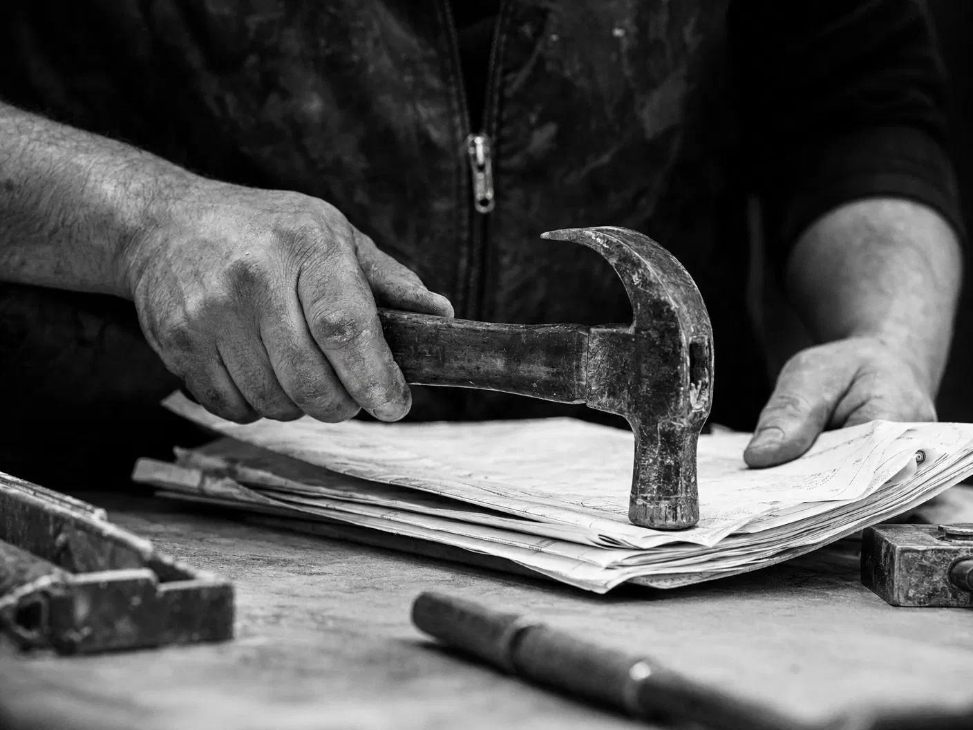 Black and white hands with tools and paperwork