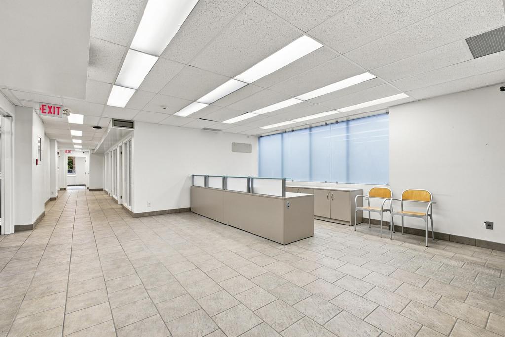 Reception area and corridor with existing private offices at 51 Eglinton Avenue East
