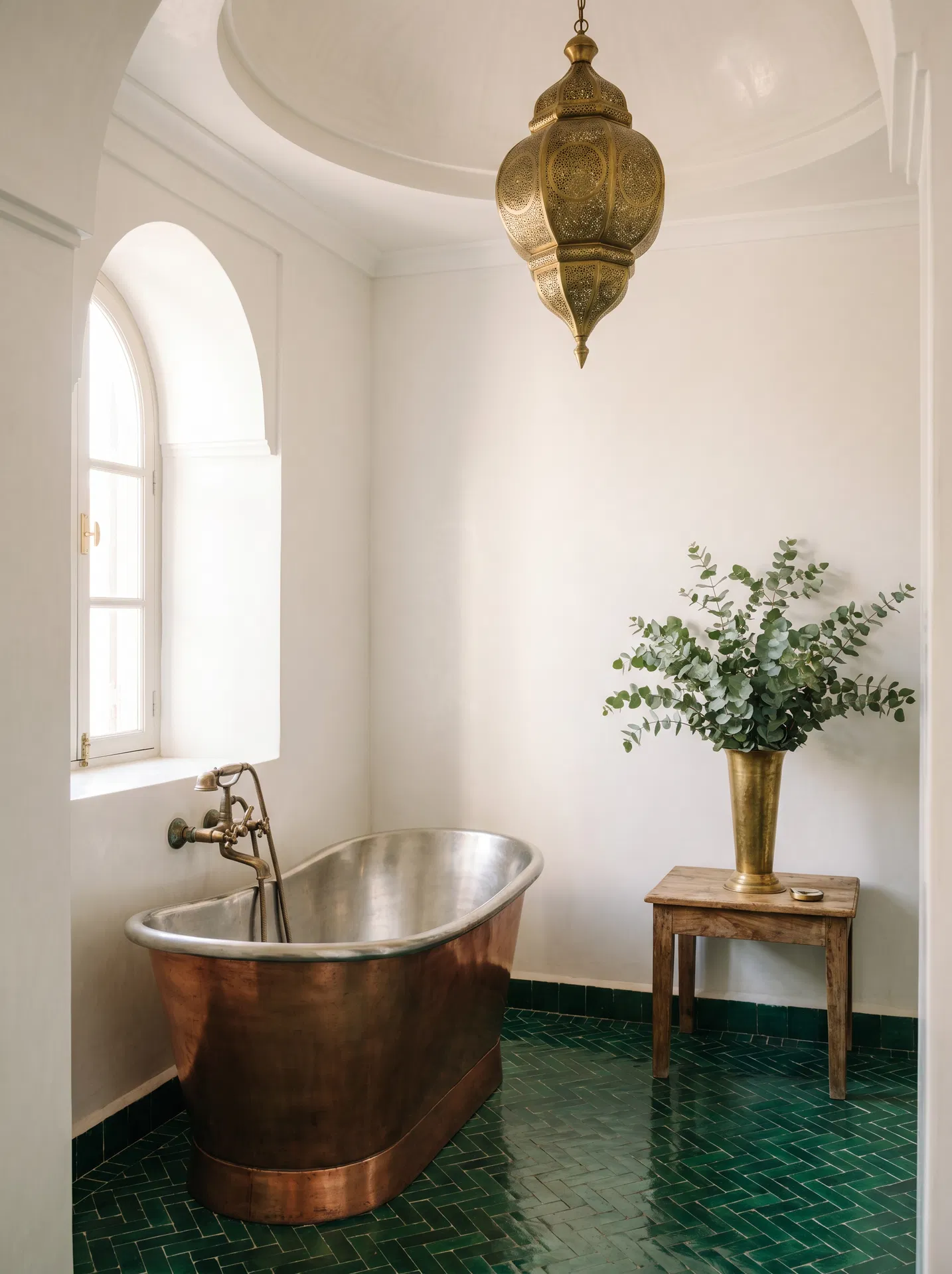Luxury Moroccan riad bathroom with copper bathtub and brass fixtures