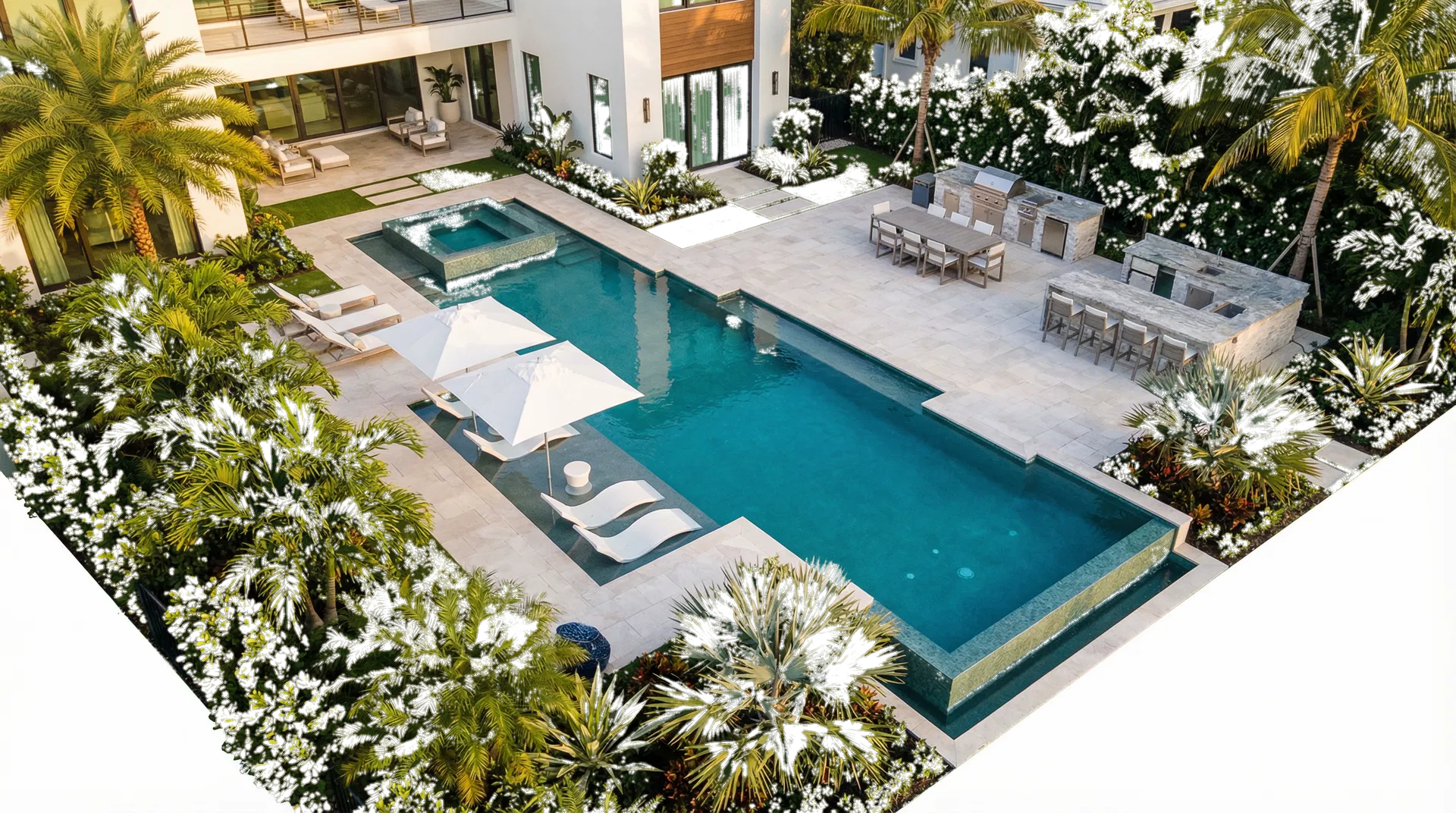 Aerial view of a complete luxury backyard with pool, spa, and outdoor kitchen.
