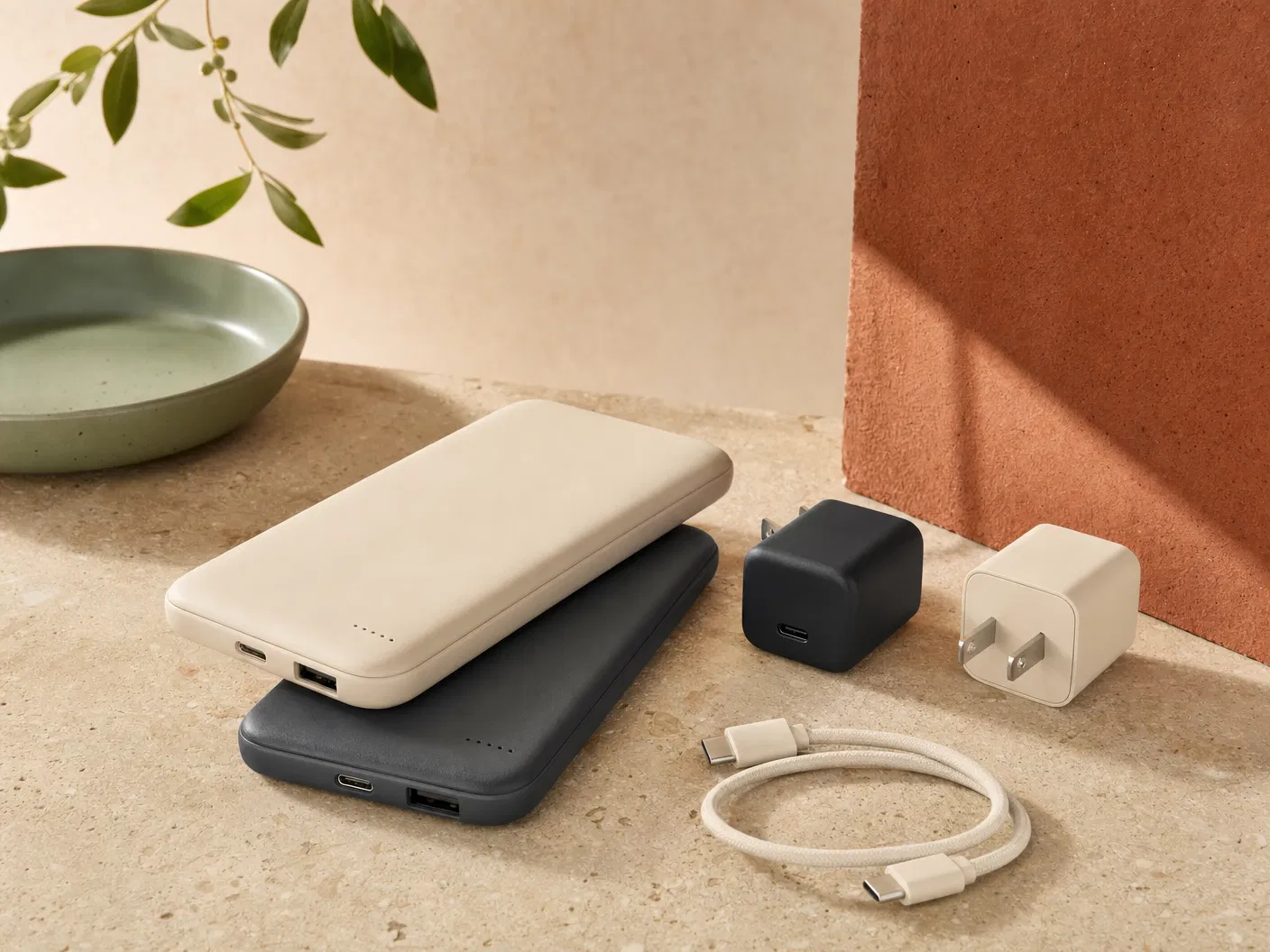 Unbranded compact wall charger with cable on warm stone surface