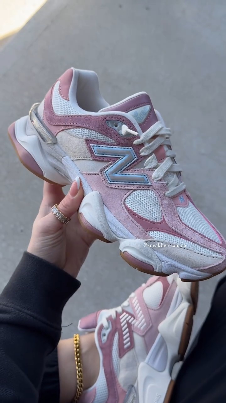 New Balance pink and white sneakers — chunky sole, 'N' logo with light blue outline, textured mesh panels, suede overlays, metallic silver accents, gum sole details