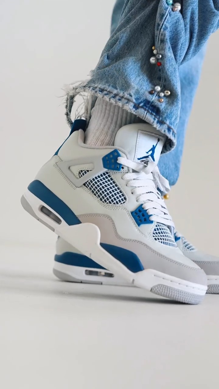 Nike Air Jordan 4 white, grey, royal blue sneakers — mesh side panels, plastic lace eyelets, visible air unit in sole, Jumpman logo on tongue, white laces, multi-panel construction