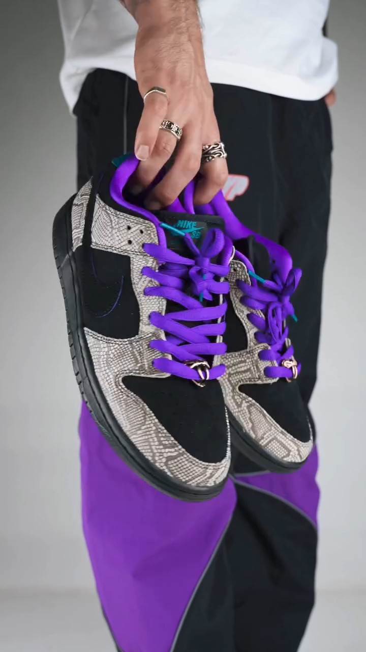 Nike SB Dunk Low black, purple, grey snakeskin sneakers — snakeskin print overlays, contrasting purple laces, black suede panels, turquoise accents, gold lace dubraes, Nike Swoosh
