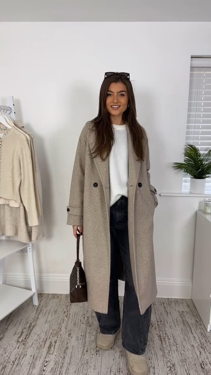 minimalist casual chic light beige heather long coat — double-breasted, notched lapel, dropped shoulders, long sleeves with buttoned tabs, side pockets