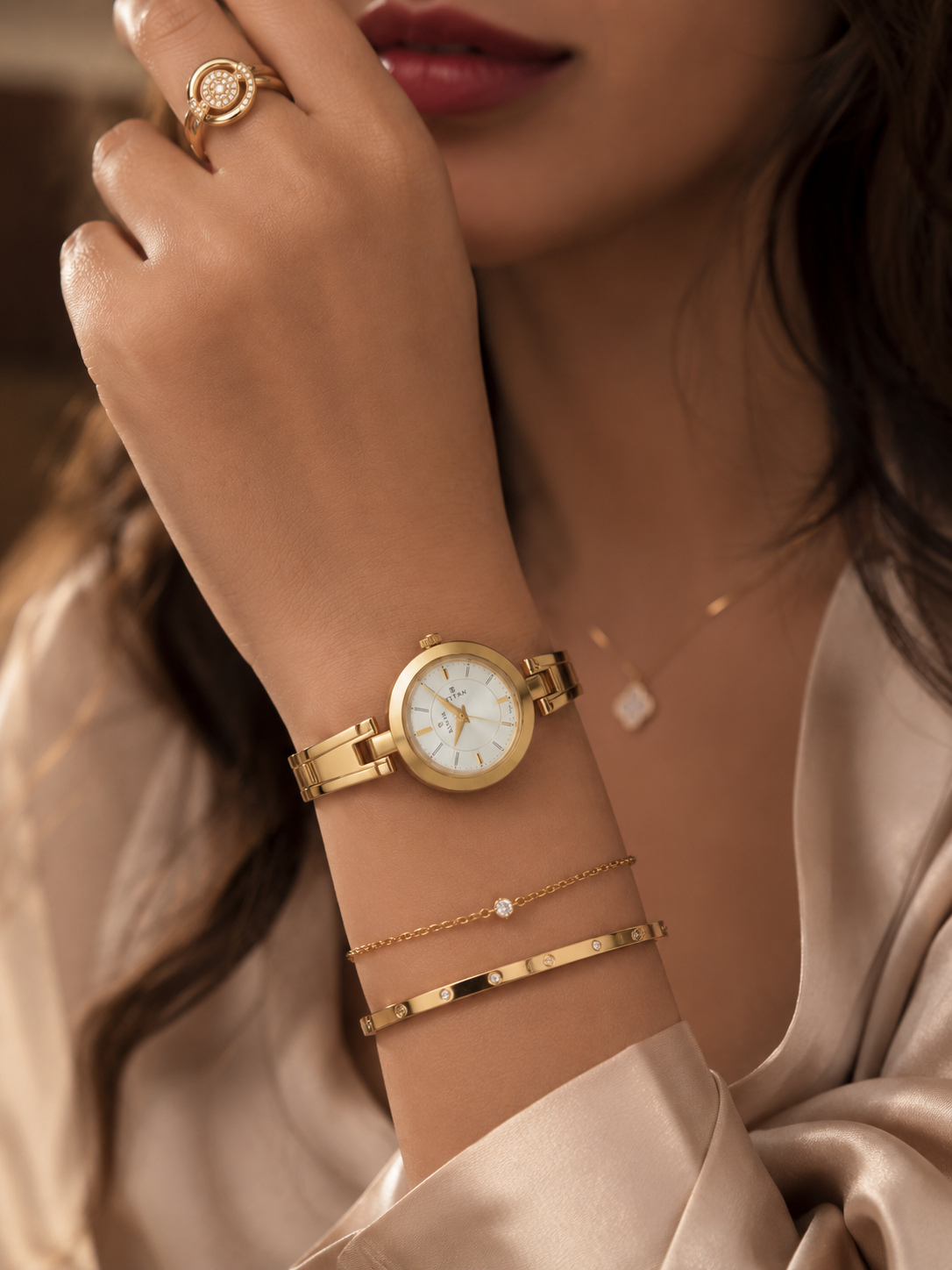 Titan gold wristwatch — round case, white dial, minimalist hour markers, link bracelet, 'TITAN' logo on dial