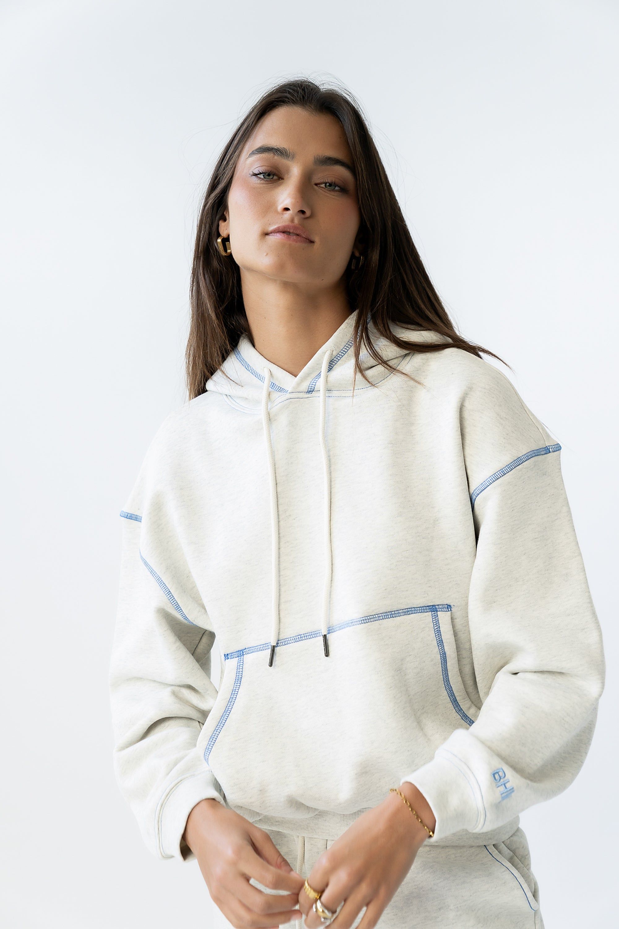 casual heather grey hoodie — drawstring hood, kangaroo pocket, exposed blue contrast stitching, raglan sleeves