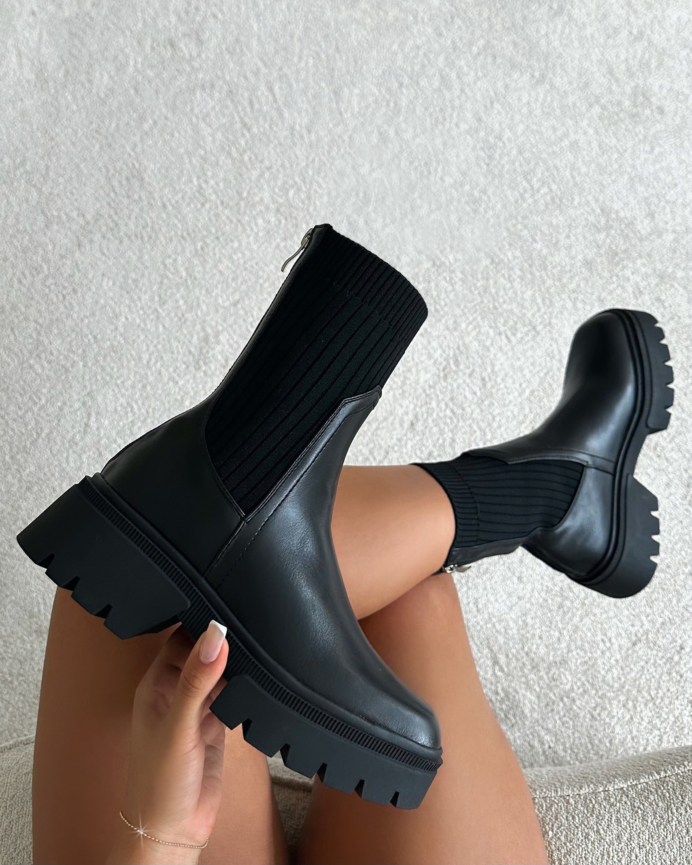 streetwear black ankle boots — ribbed knit cuff, lug sole, side zipper, pull tab